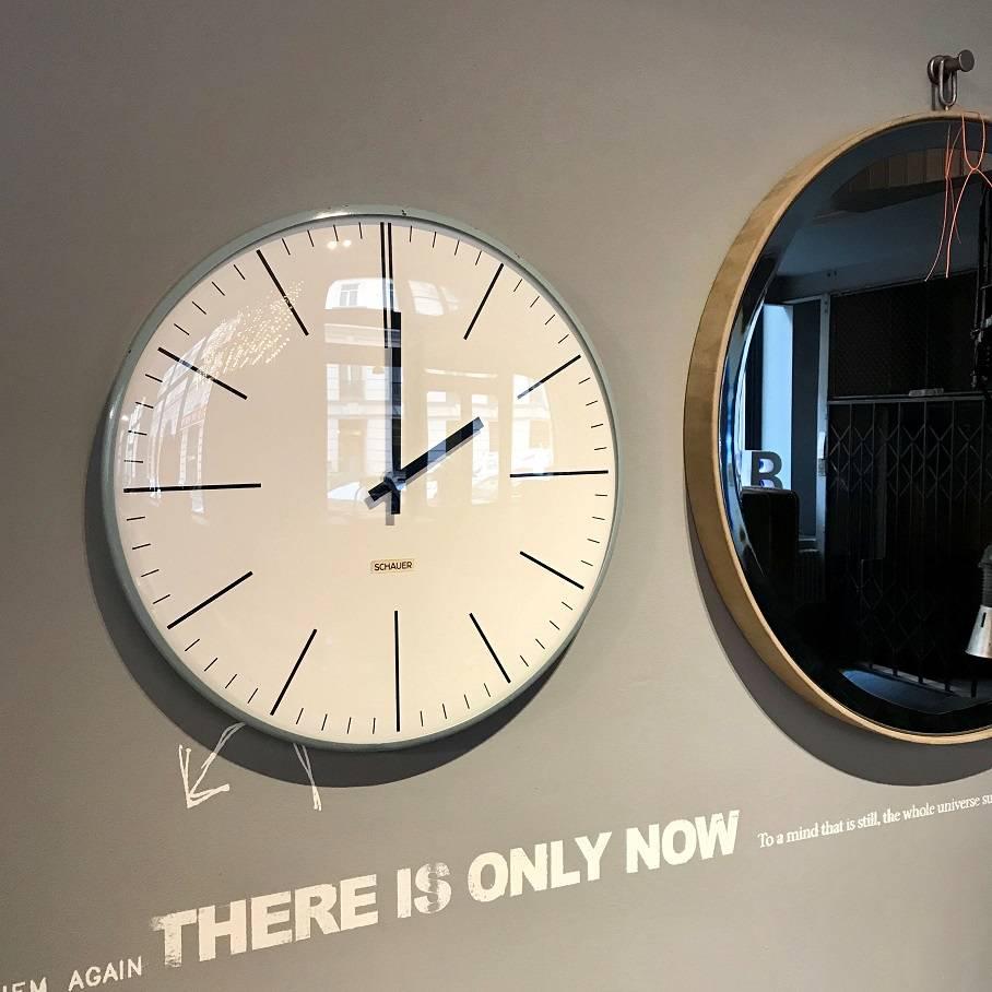 Big wall clock made by Schauer, Vienna in 1970s. Very elegant, slim-line Industrial clock in the style of Max Bill. Grey/blue painted steel body, domed glass and a dial made of hard plastic similar to bakelite. Great condition, now fitted with a