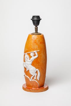 Orange glazed ceramic table lamp with a horseman, circa 1940-1950.