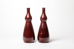 Red glazed stoneware pair of bottles by Accolay, circa 1960-1970.