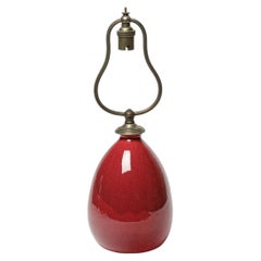 Red glazed ceramic table lamp by Jean Besnard, circa 1930.