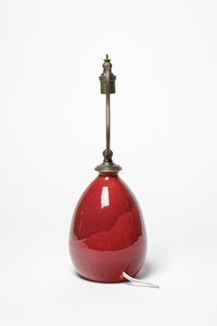 Red glazed ceramic table lamp by Jean Besnard, circa 1930.