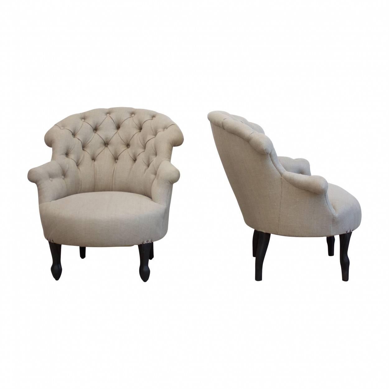 A near matching pair of French armchairs which have been newly upholstered in a beautiful natural linen fabric.

One chair is circa 1900 whilst the other is a very good quality chair from circa 1950.

Measures: 83cm high, 79cm wide and 70cm deep.