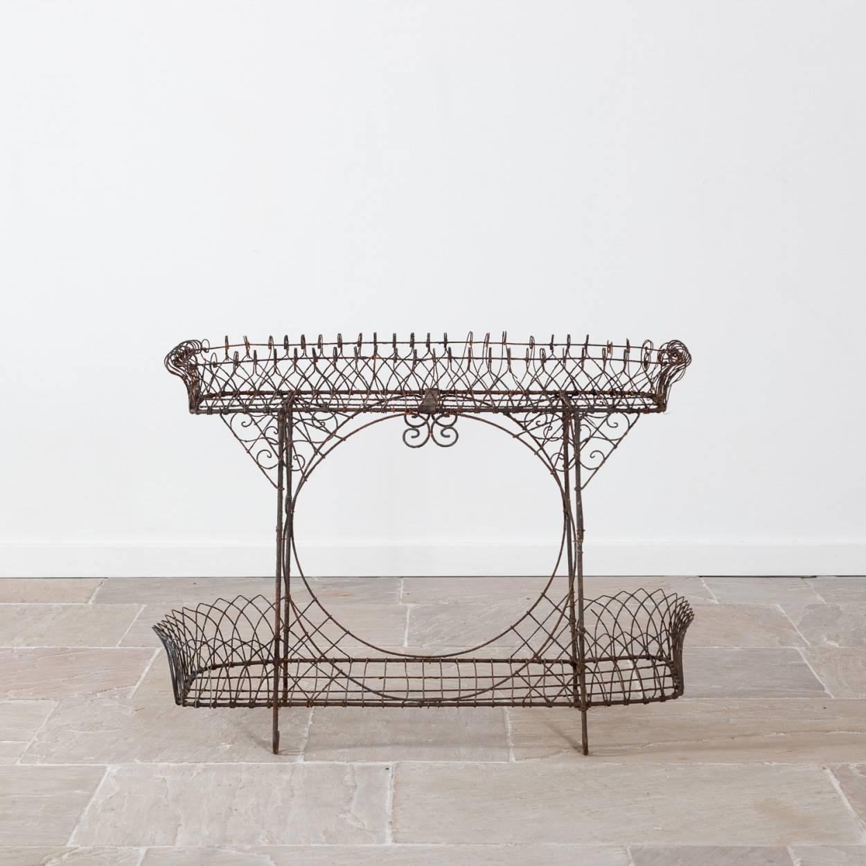 This is a beautiful Regency wirework plant stand, which is quite unusual in that it is deeper than most stands of this shape.

It is in very good condition for a piece of this age with only a few small breaks.

Measure: 82cm high, 107cm wide and