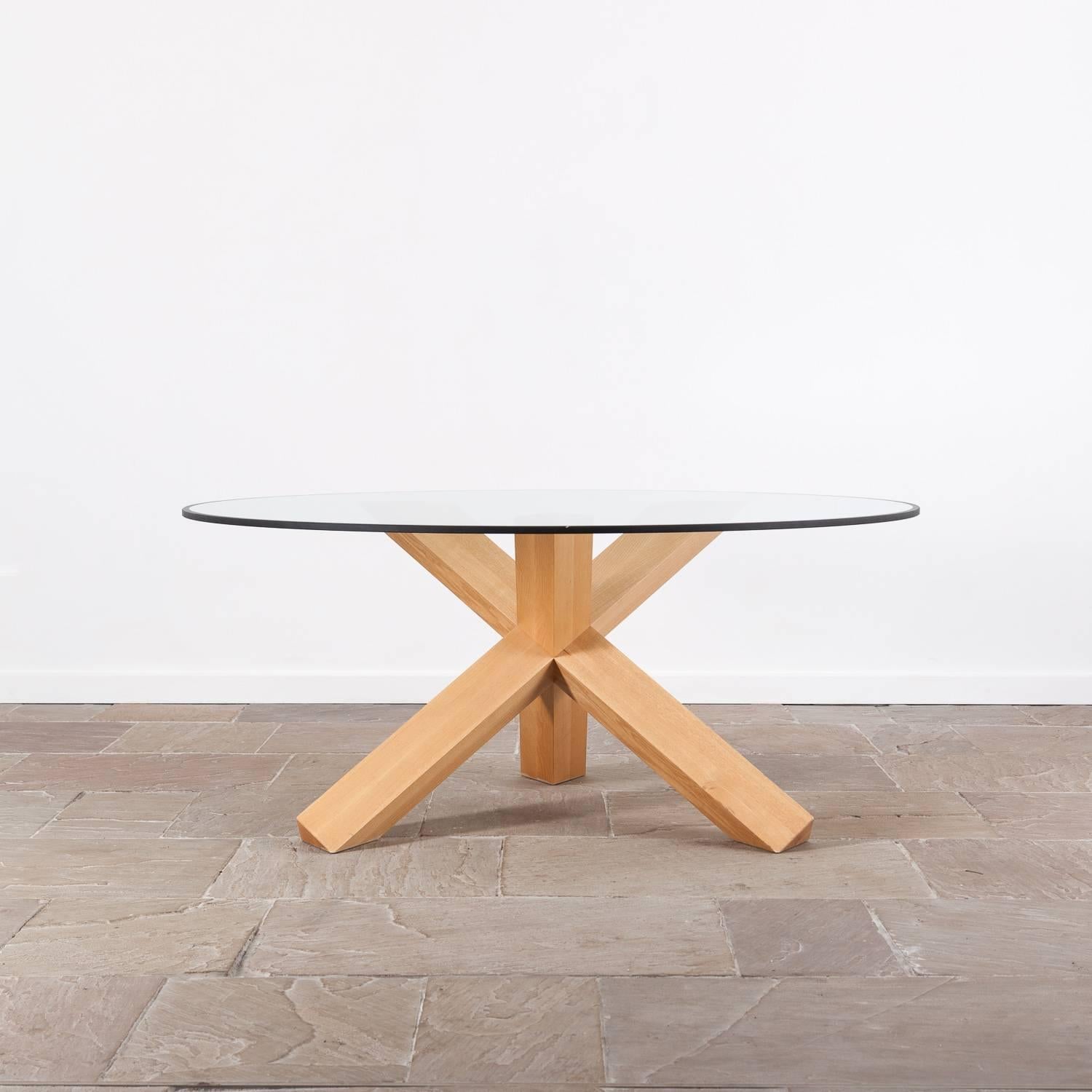 La Rotonda dining table by Mario Bellini for Cassina. Originally designed in 1976.

Glass topped table with a natural ash base. 

There are two chips on the outer edge of the very substantial glass top other than this it is in good condition
