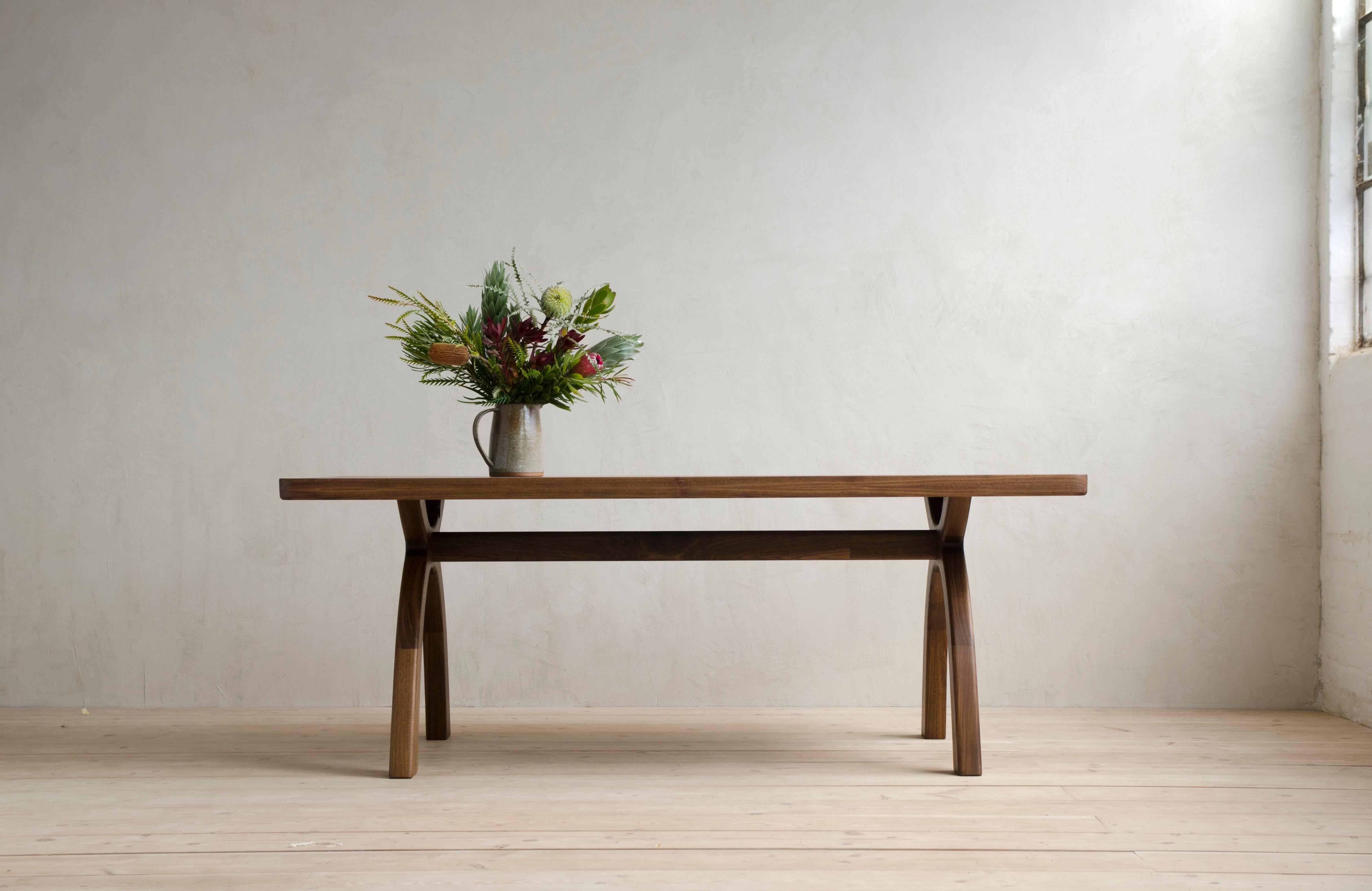 The original piece in the Inyo Collection.  Arched legs transition smoothly into thick, solid-wood top