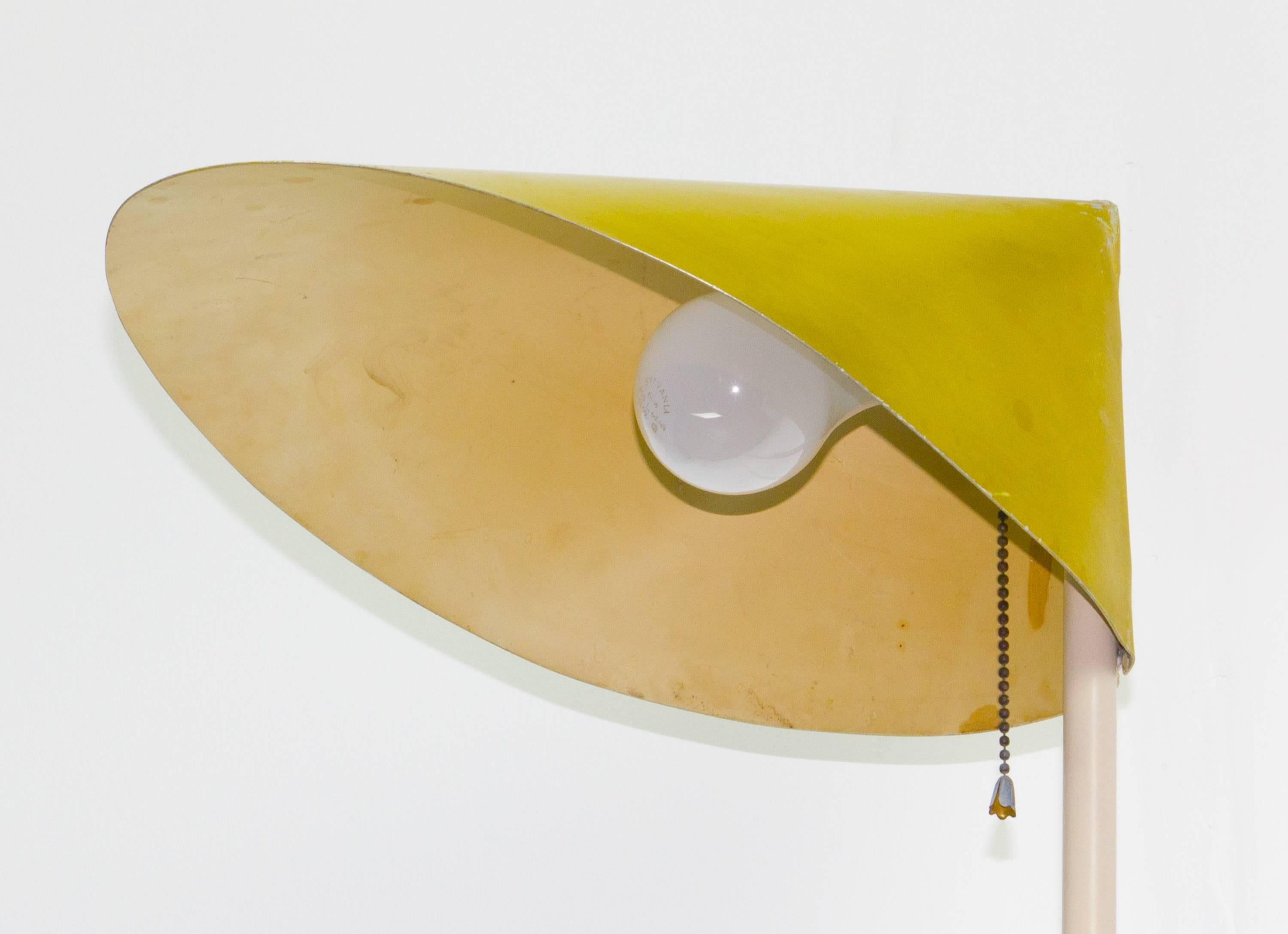 Scarce floor lamp variant of the Model 2016 lamp by Svend Aage Holm Sørensen, designed in 1954. This example has a yellow enameled steel angle base and conical wrapped sheet metal shade.