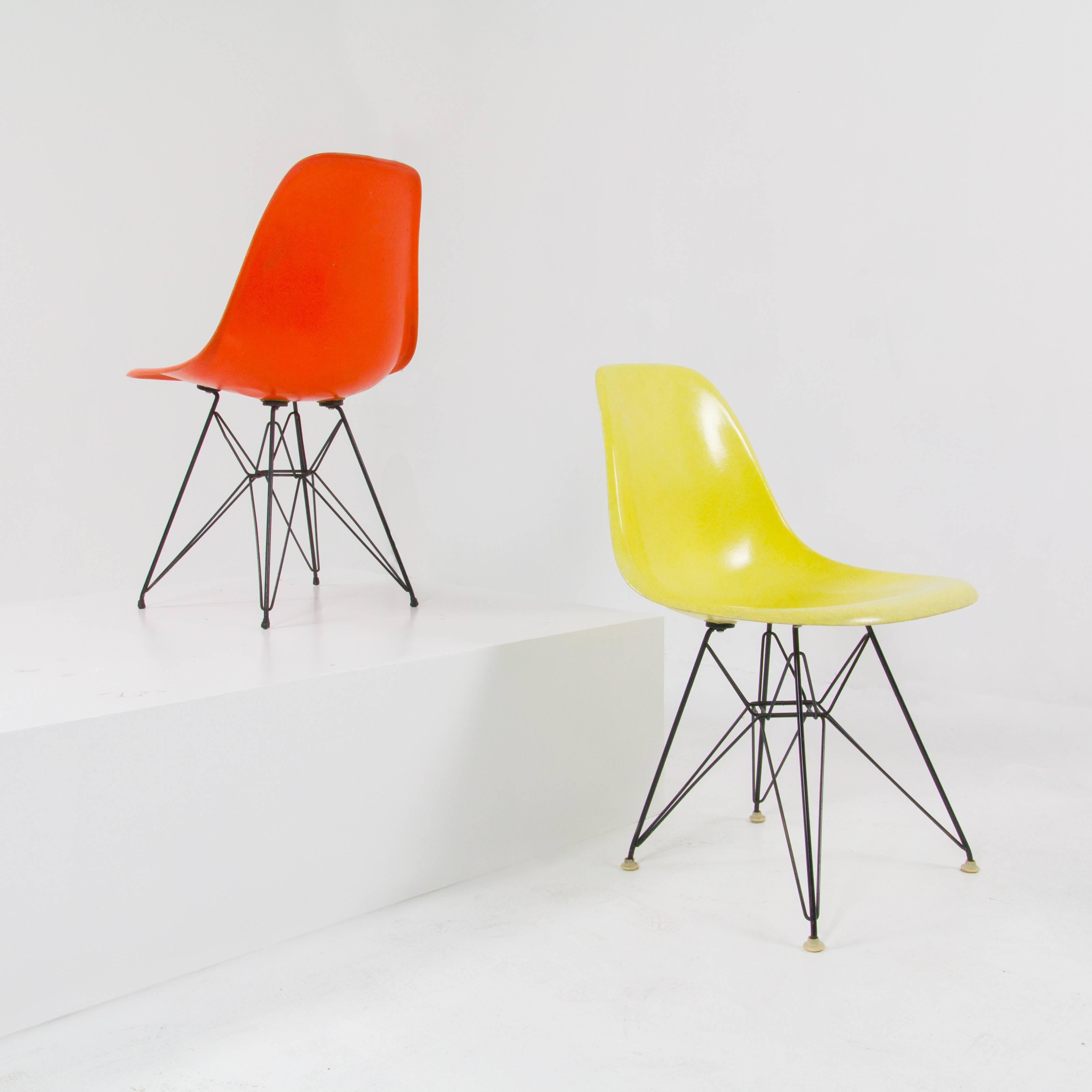 Set of four DSR fiberglass shell chairs by Charles and Ray Eames for Herman Miller with wire Eiffel bases and original hardware.