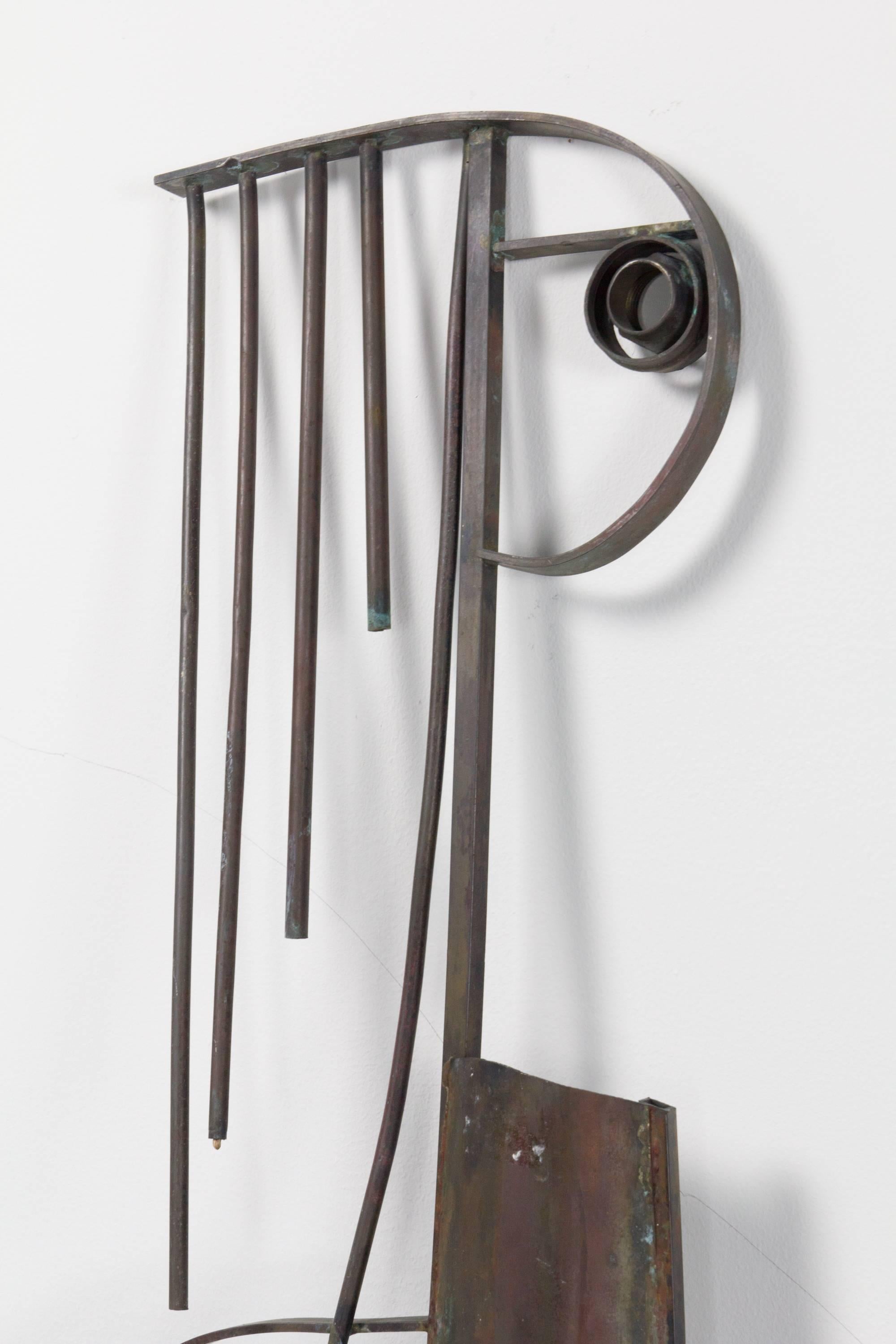 Leaning or mounted sculpture of a woman by Peter Janssen comprised of sheet metal elements and found hardware detail.