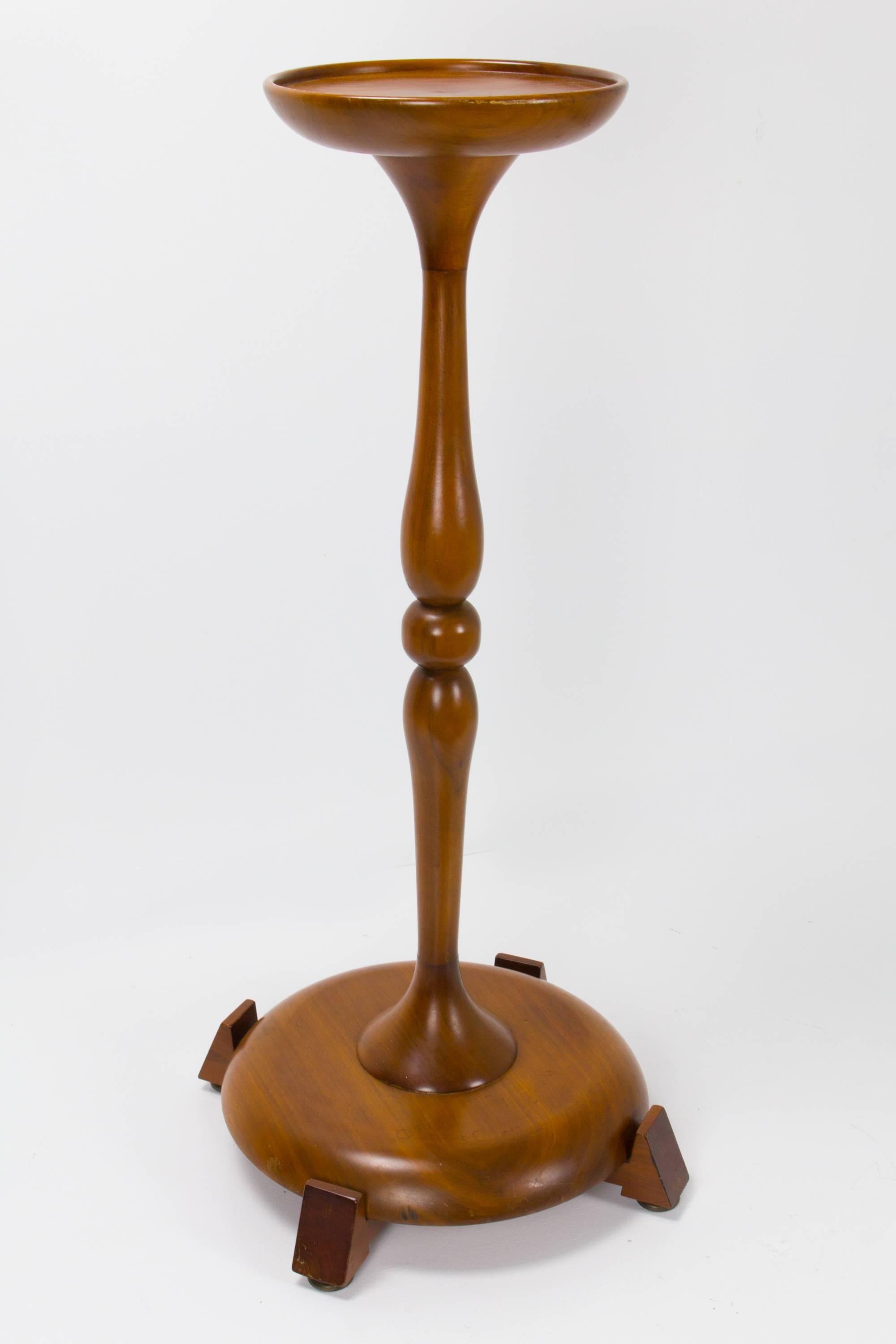American Studio craft movement pedestal in walnut by Robert Whitley with fine carved and turned detail. Incised signature to base. The diameter of the pedestal is 10.5 inches.