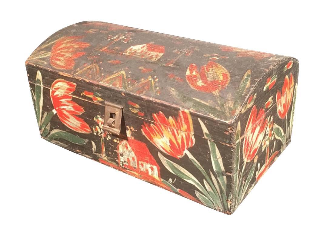 Decorated dome top box. Attributed to Heinrich Bucher, Berks County, Pennsylvania. Pine with typical painted decoration of white, red and yellow tulips and rare example decorated with three houses and bold tulips. Tin and wire staple hinges and