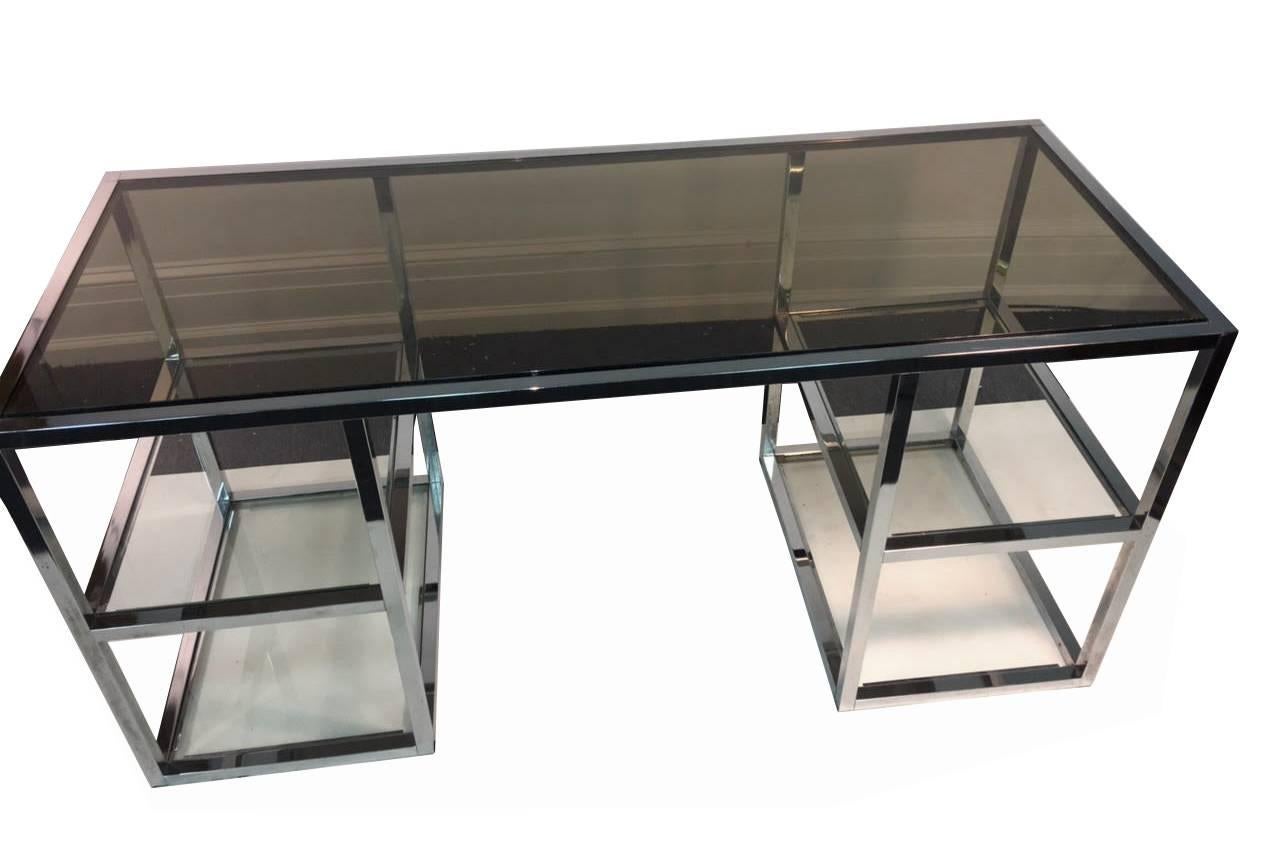 Italian 1970's Chrome Frame Modernist Desk with Smoky Grey Glass Top and Two Clear Glass Open Square Shelves on Both Sides Of The Center. Designed By Romeo Rega.A Great Open Style Desk That Is Ideal for a Computer Station.


