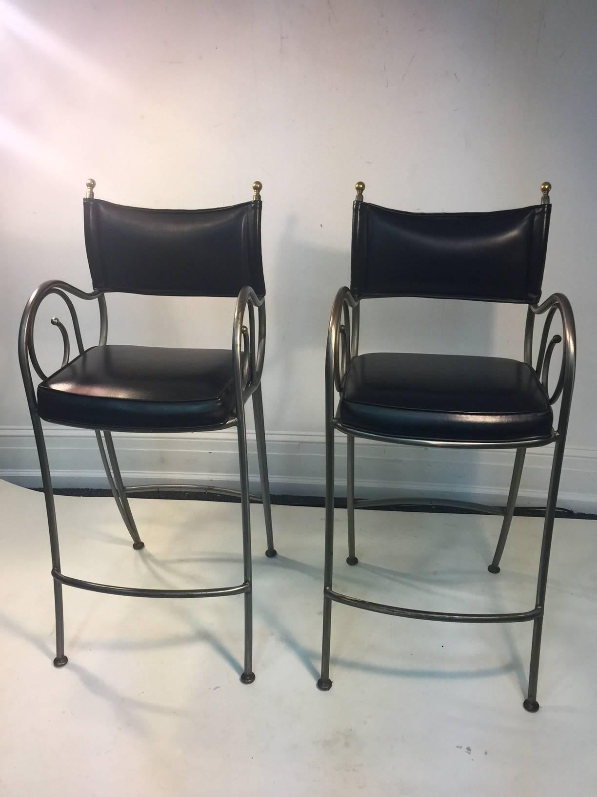 Elegant Pair of High Style Bar Stools with Brushed Curved Tubular Steel Design with Brass  Ball Accents and Black leatherette upholstery Designed in The 1970's..