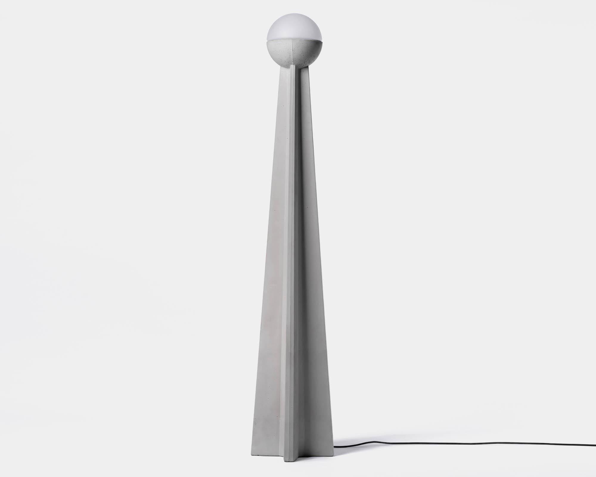 Nie M - Floor lamp by Bentu Design.

Concrete, glass, aluminum
Measures: 300 x 300 x H 945mm
22kg
Light source: E27 250lm 2700K AC 100-240V 50-60Hz 9W IP20 
Cord: 3.5m black

Bentu Design's furniture and lightings derive its uniqueness from