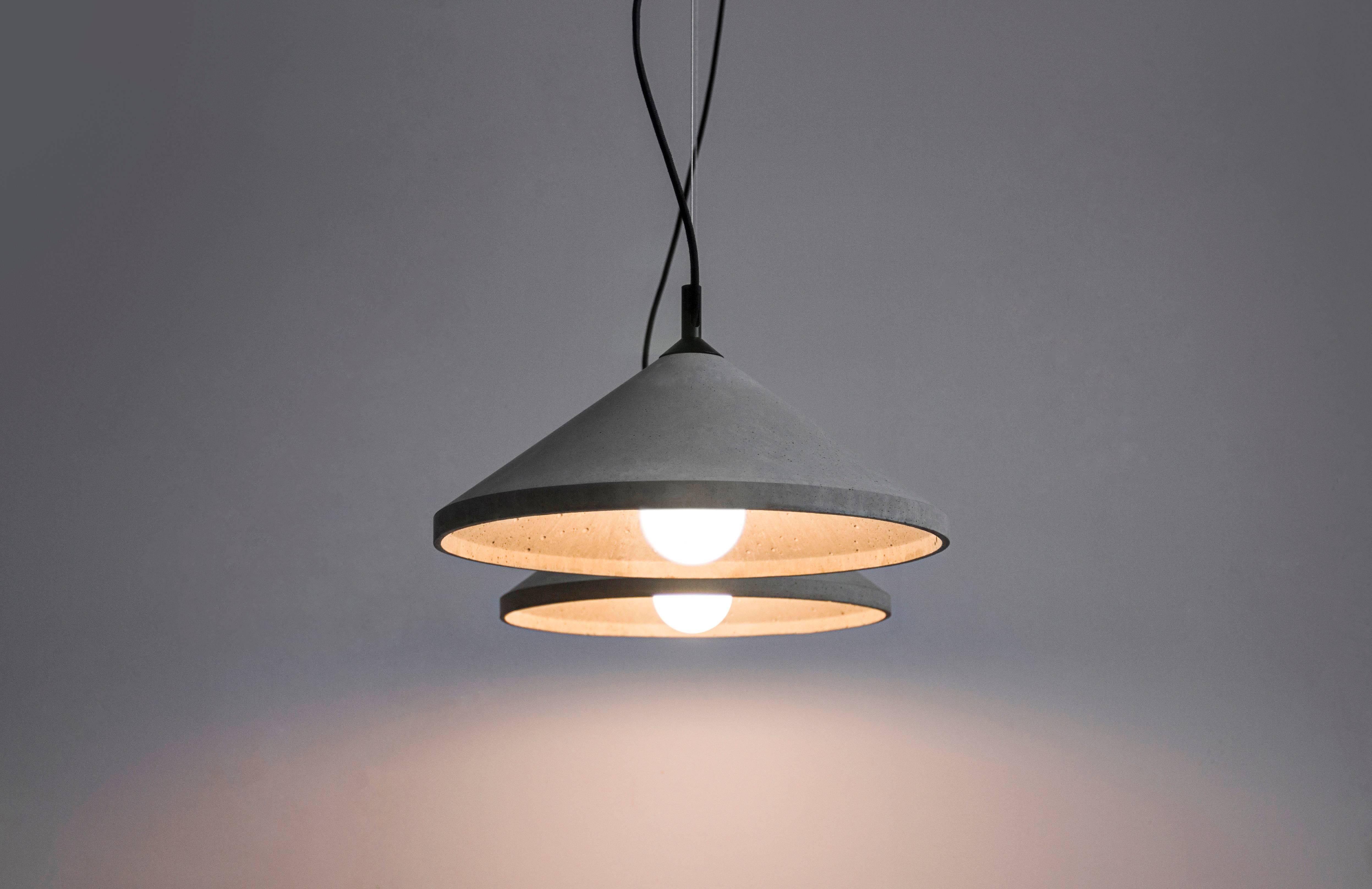 Ren 3
Concrete ceiling lamp designed by Cantonese studio Bentu Design

21 cm High; 40 cm Diameter
Concrete
Black wire 2m adjustable. 
Bulb E27 LED 7W 100-240V 80Ra 700LM 3400K

These pendant lamps are available in 3 different dimensions with two