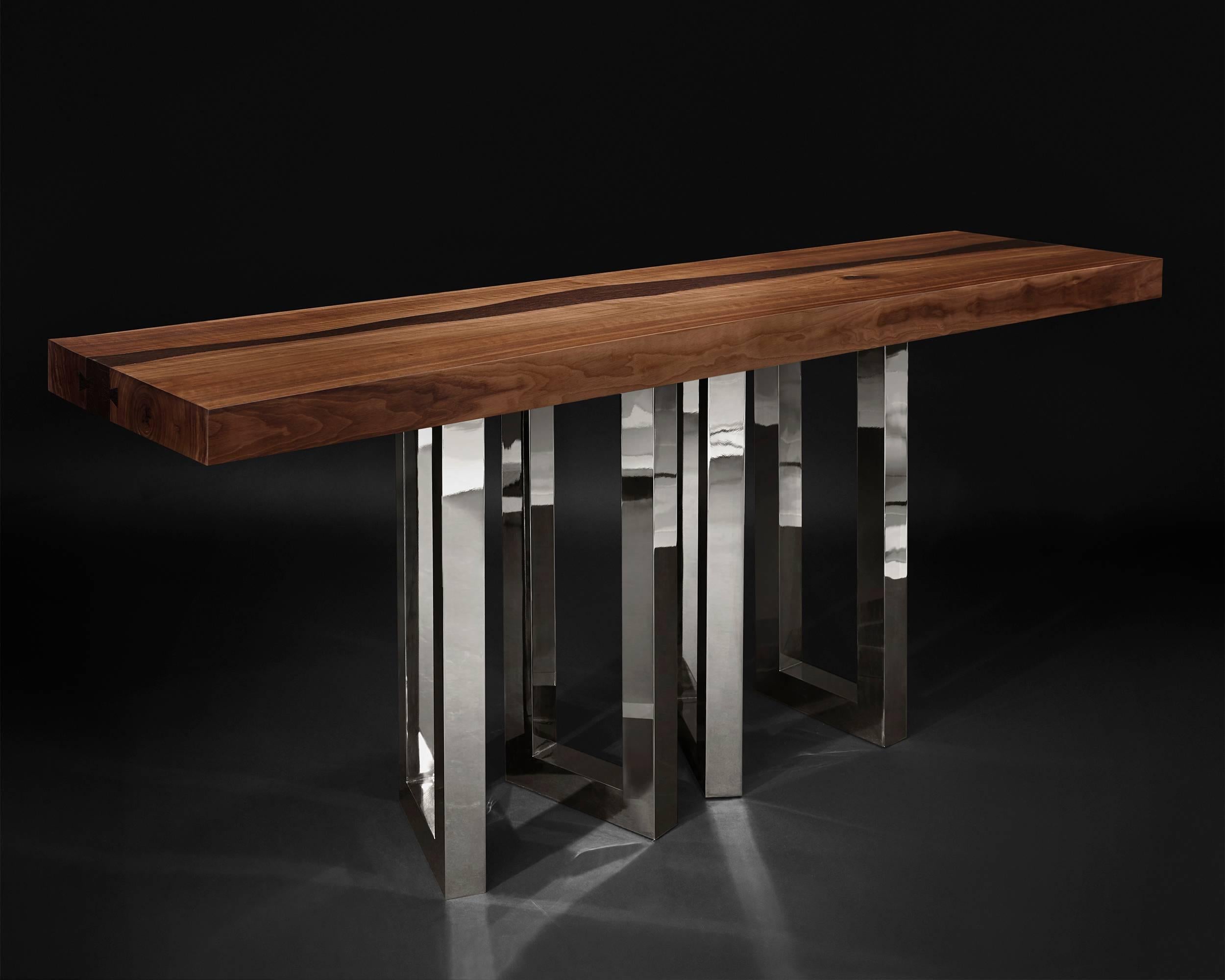 A solid block of walnut held up by what seems to be a casually arranged group of glittering legs. A composite of contrasting elements, massive and sophisticated, strong and passionate; Il Pezzo 6 Console is a harmonious and timeless whole.
The