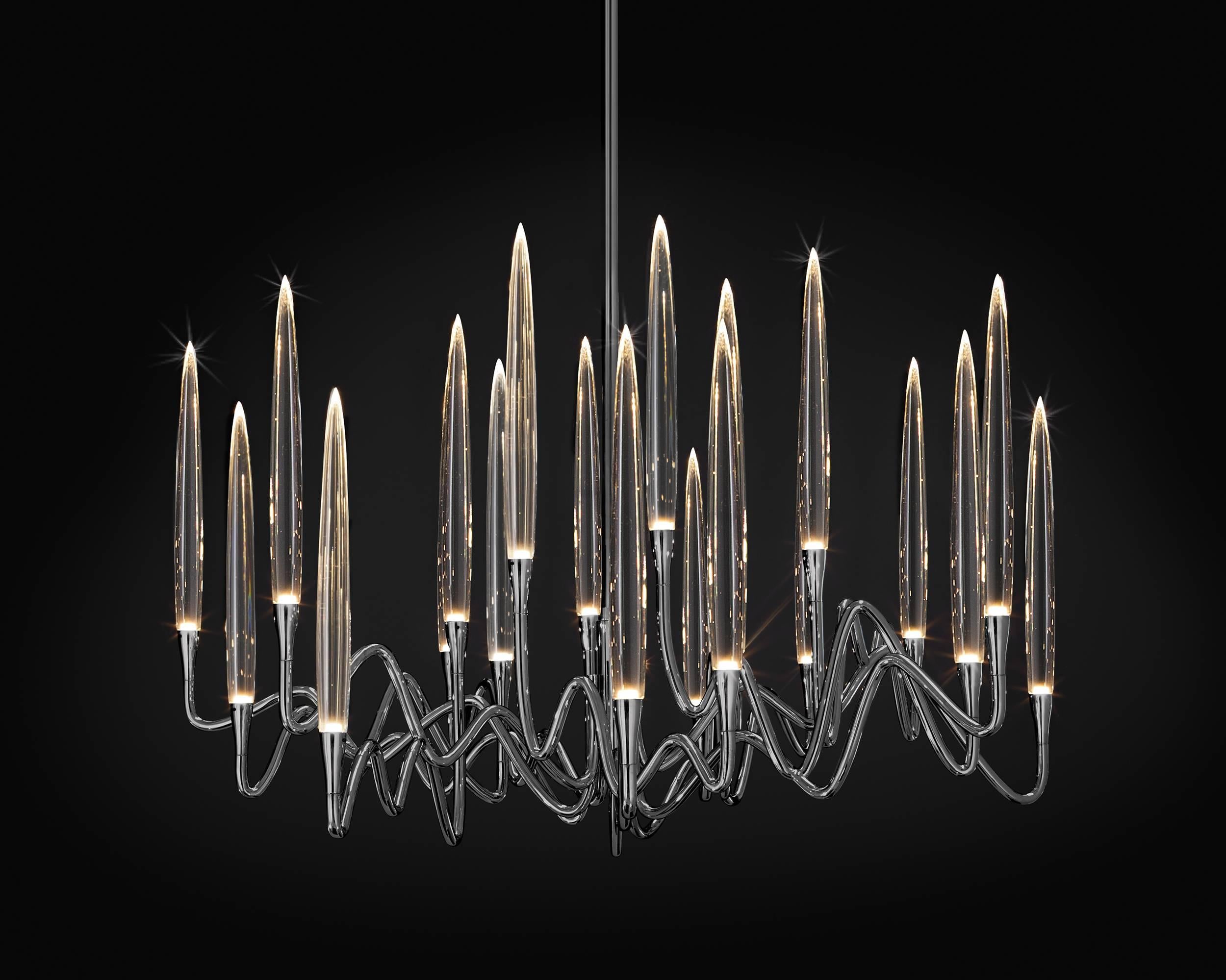 Inspired by Arabic calligraphic art and the icon of the classical candelabrum is Il Pezzo 3 Chandelier, with a hand-forged brass structure and elegant “candles” crafted from solid crystal.
The candles are illuminated using the latest LED technology,