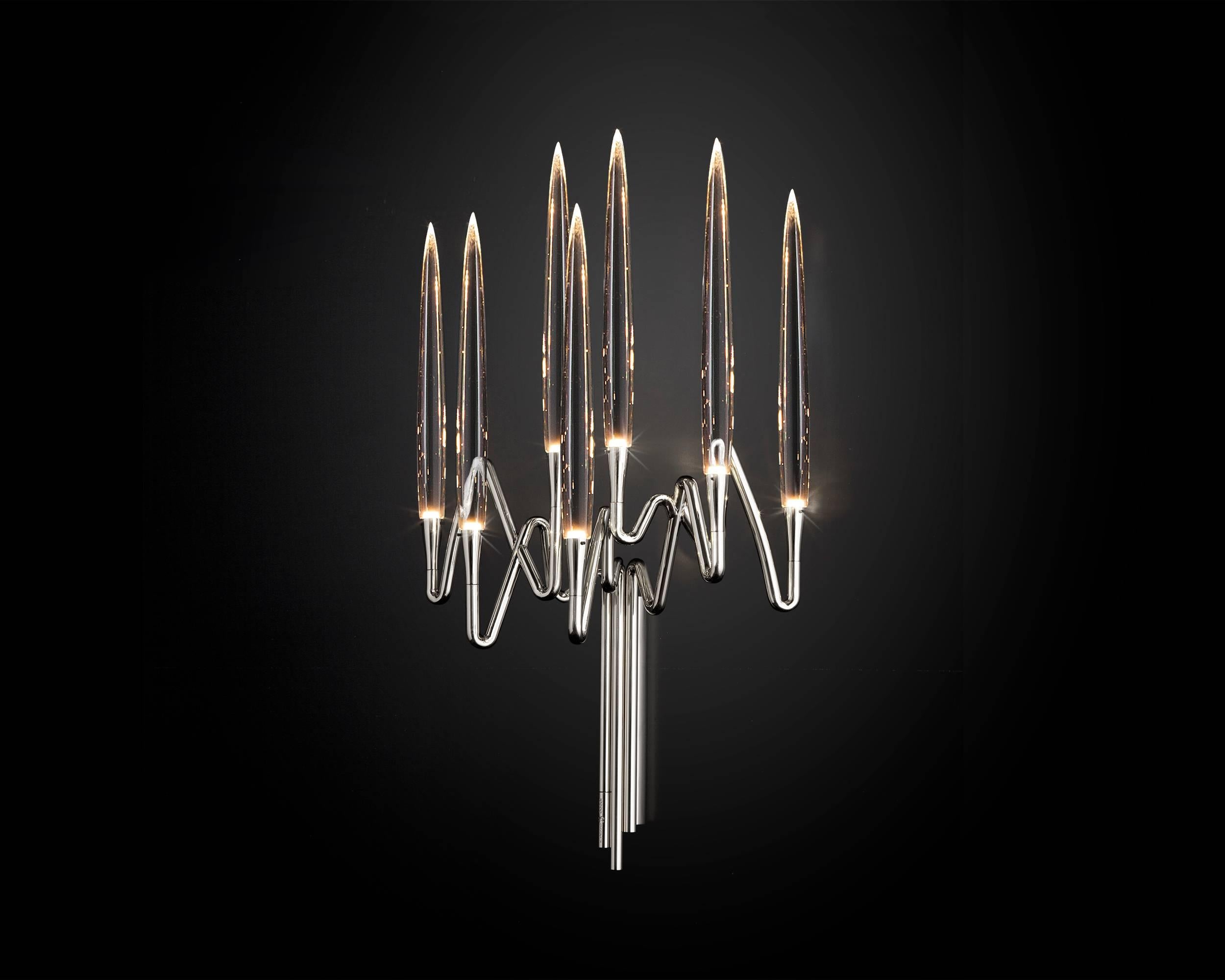 Inspired by Arabic calligraphic art and the icon of the classical candelabrum is Il Pezzo 3, a collection of lamps with a hand-forged brass structure and elegant “candles” crafted from hand blown crystal, according to the noble Tuscan artisan