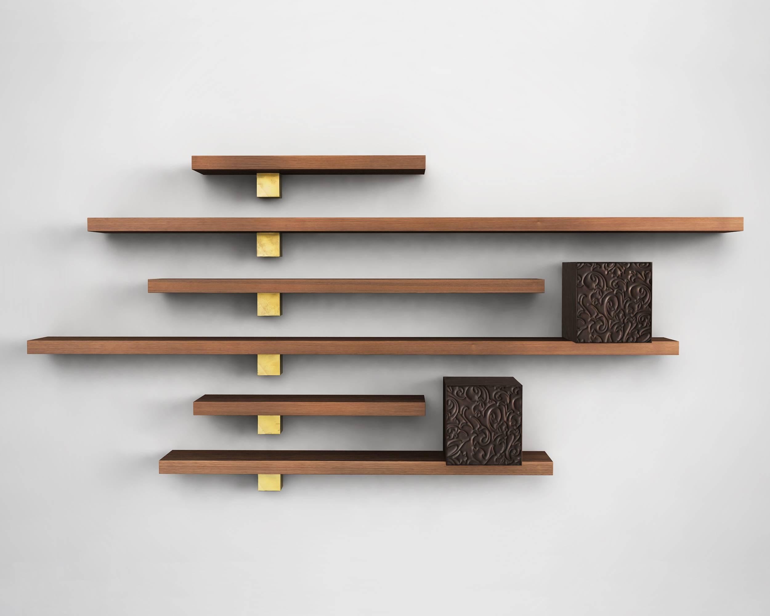 The delicate pattern of carvings, the precious grain of the solid walnut and the brightness of the brass castings give rhythm to wall the pieces are on, creating sophisticated solutions, for preserving and exhibiting. 
Il Pezzo 5 is a numbered
