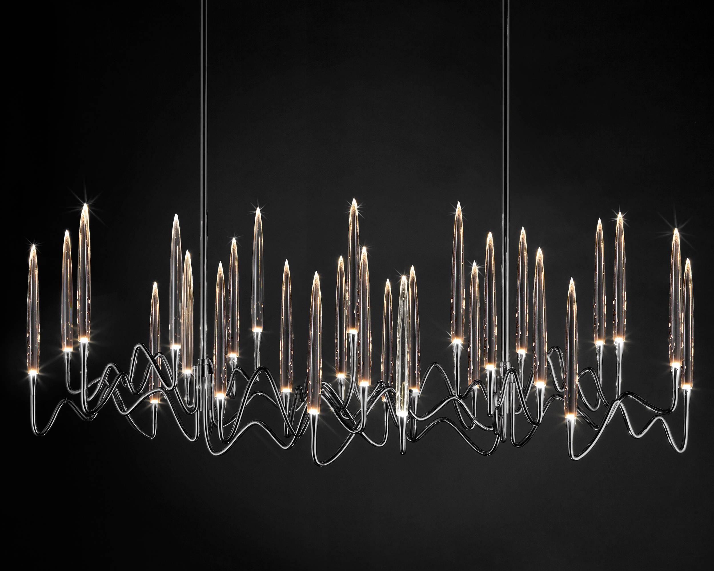 Inspired by Arabic calligraphic art and the icon of the classical candelabrum is Il Pezzo 3 chandelier, with a hand-forged brass structure and elegant “candles” crafted from solid crystal.
The candles are illuminated using the latest LED technology,