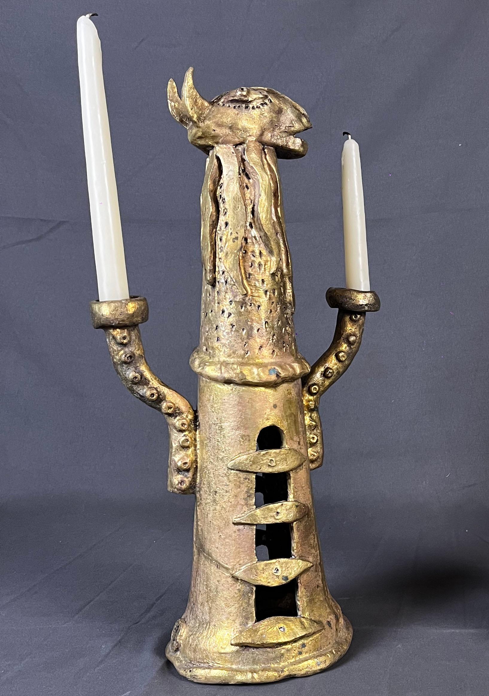 A heavy cast bronze sculptural candelabra by French sculptor Eric Ledoux. The candelabra shows a goat head, has 10 eyes around its body and has 2 arms. The bronze shows a nice mate finish. Signed with monogram on the lower section. 

Eric Ledoux was