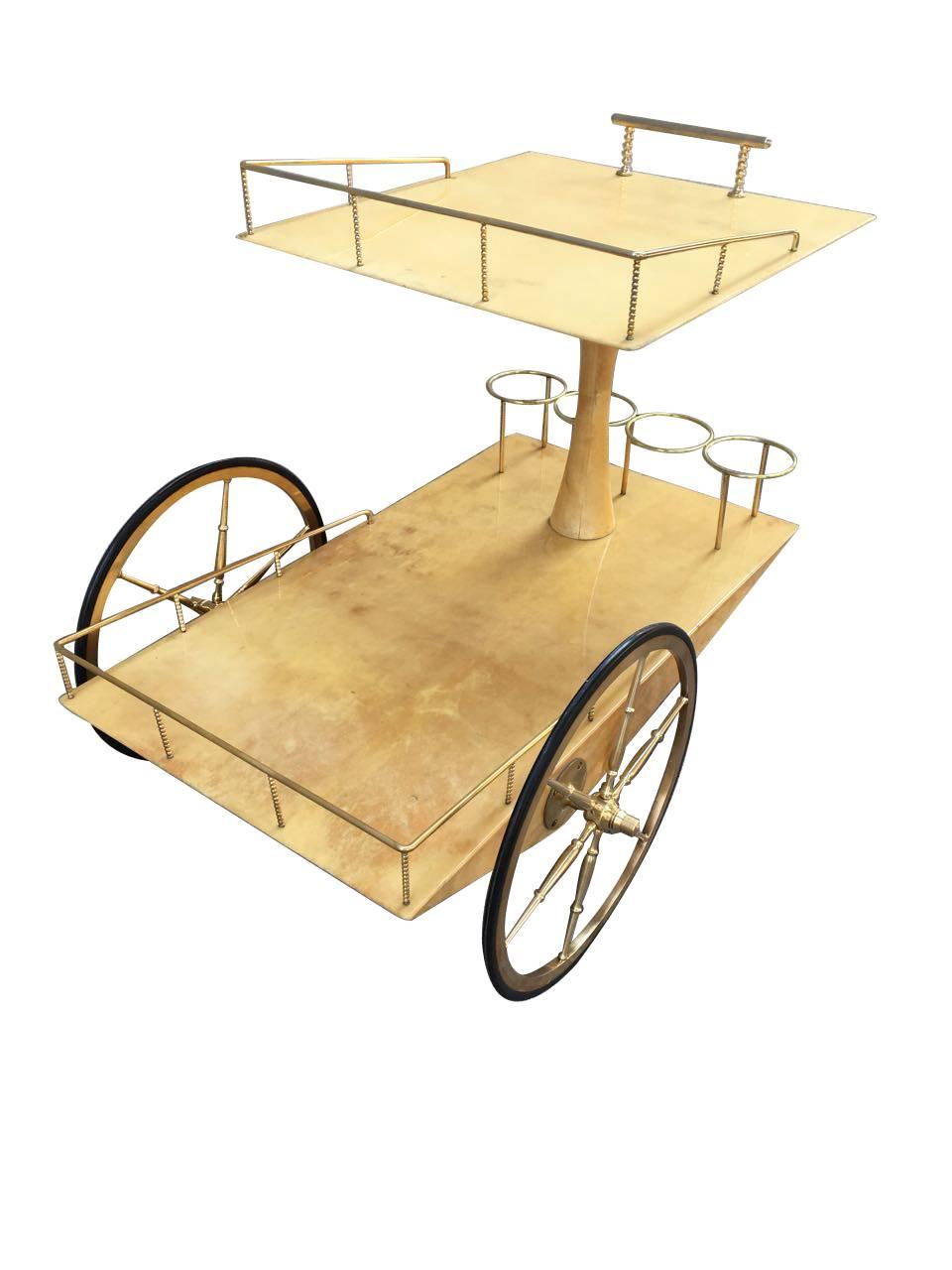 Rare Aldo Tura parchment goatskin bar cart, with a gorgeous brass structure, and bottle holders.
The Italian designer Aldo Tura established his furniture production workshop in 1939. During the postwar period, while the other Italian designers
