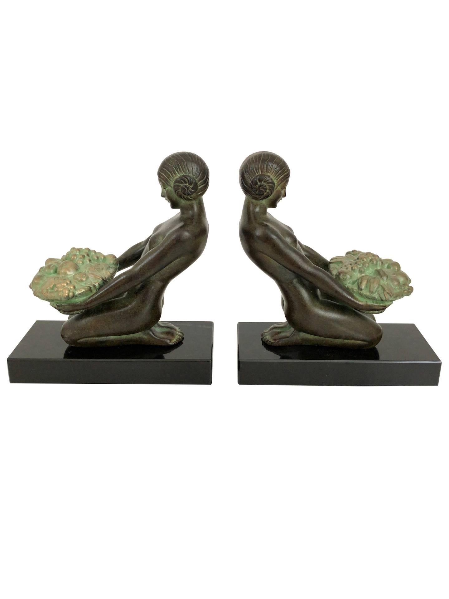 “Cueillette”
Original “Max Le Verrier”
Art Deco style, France.

Ladies with flower baskets 
Bookends made in “Régule” (spelter)
signed

Socle in black stone (could have a different marbleization than the picture) 
Green patina - Handwork,