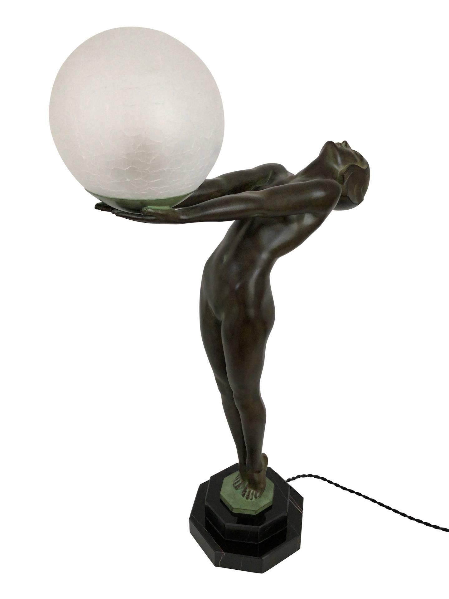 Small model of the famous Clarté
Lumina
Original Max Le Verrier, signed 
Art Deco style, France

Lighted sculpture made in Régule (spelter)
Socle in natural black stone (could have a different marbleization than the picture) 
Green patina -