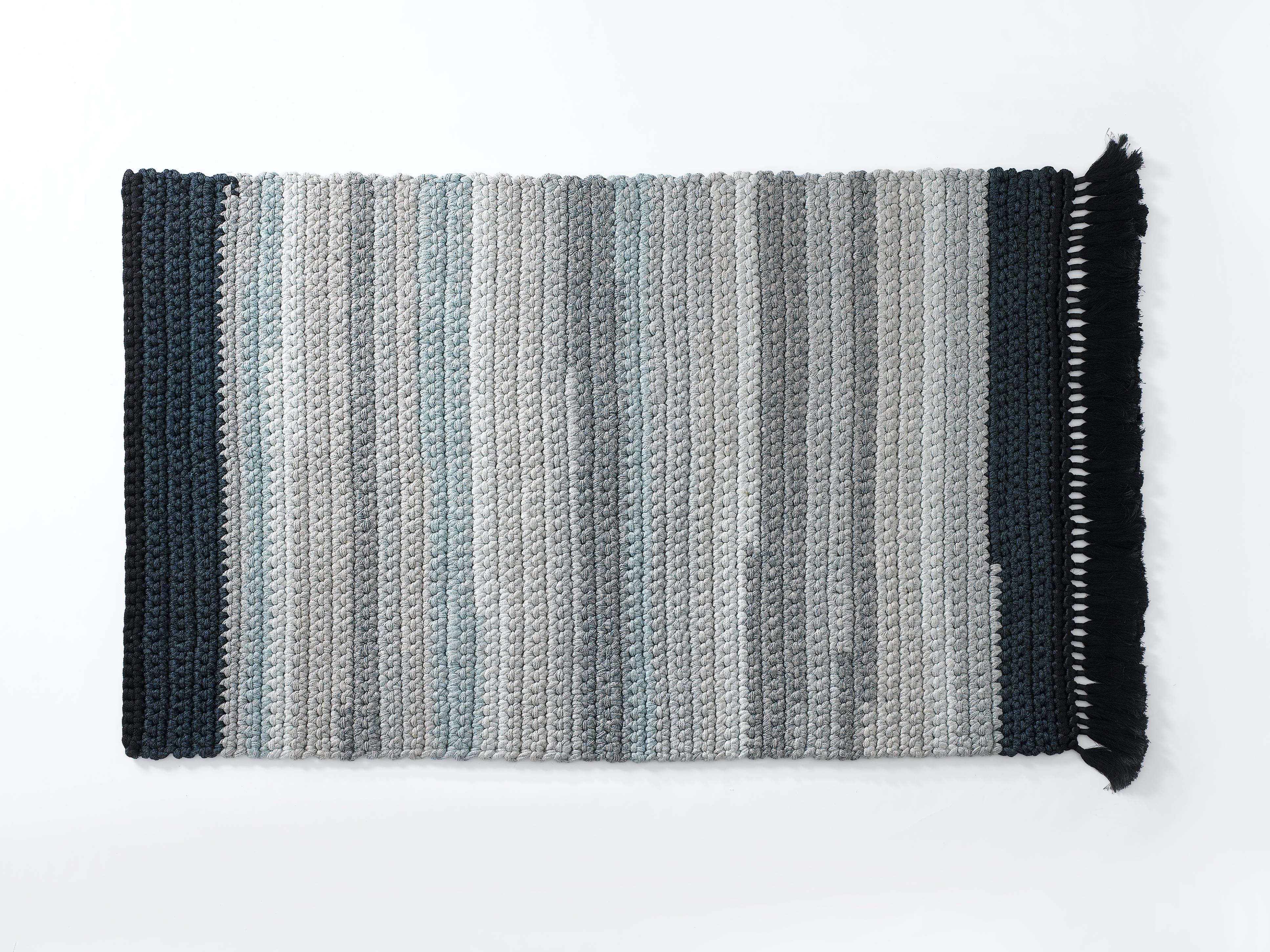 A blue and stone gradient rug that will light up any space, suitable for an intimate corner in the living space as well as for bedrooms, corridors and passages. This rug is 100% hand knit out of one continuous, color changing, soft machine knit yarn