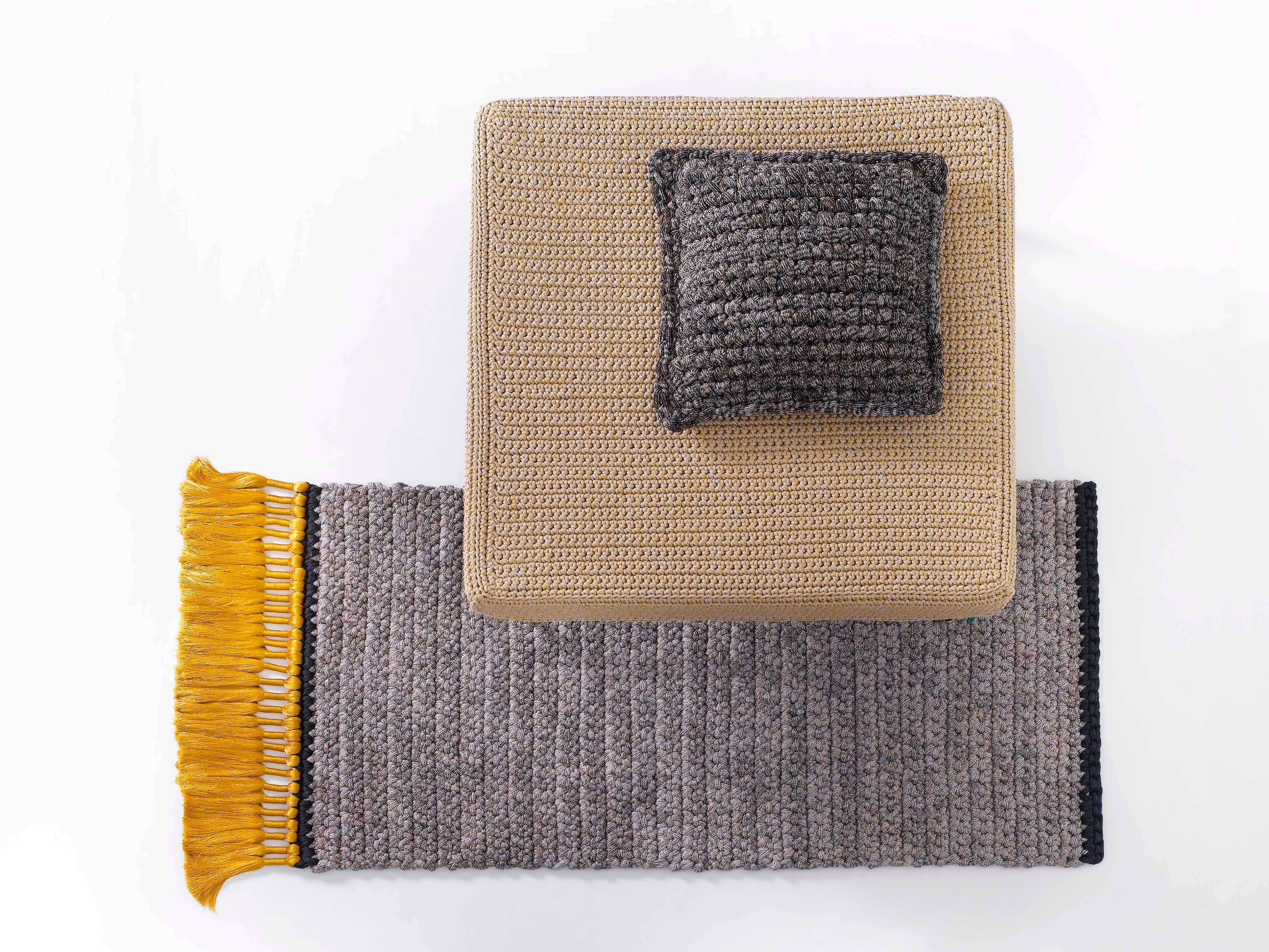 The iota grey and gold side rug that will light up any space, suitable for an intimate corner in the living space as well as for bedrooms, corridors and passages. This rug is 100% hand knit out of one continuous, soft machine knit yarn developed and