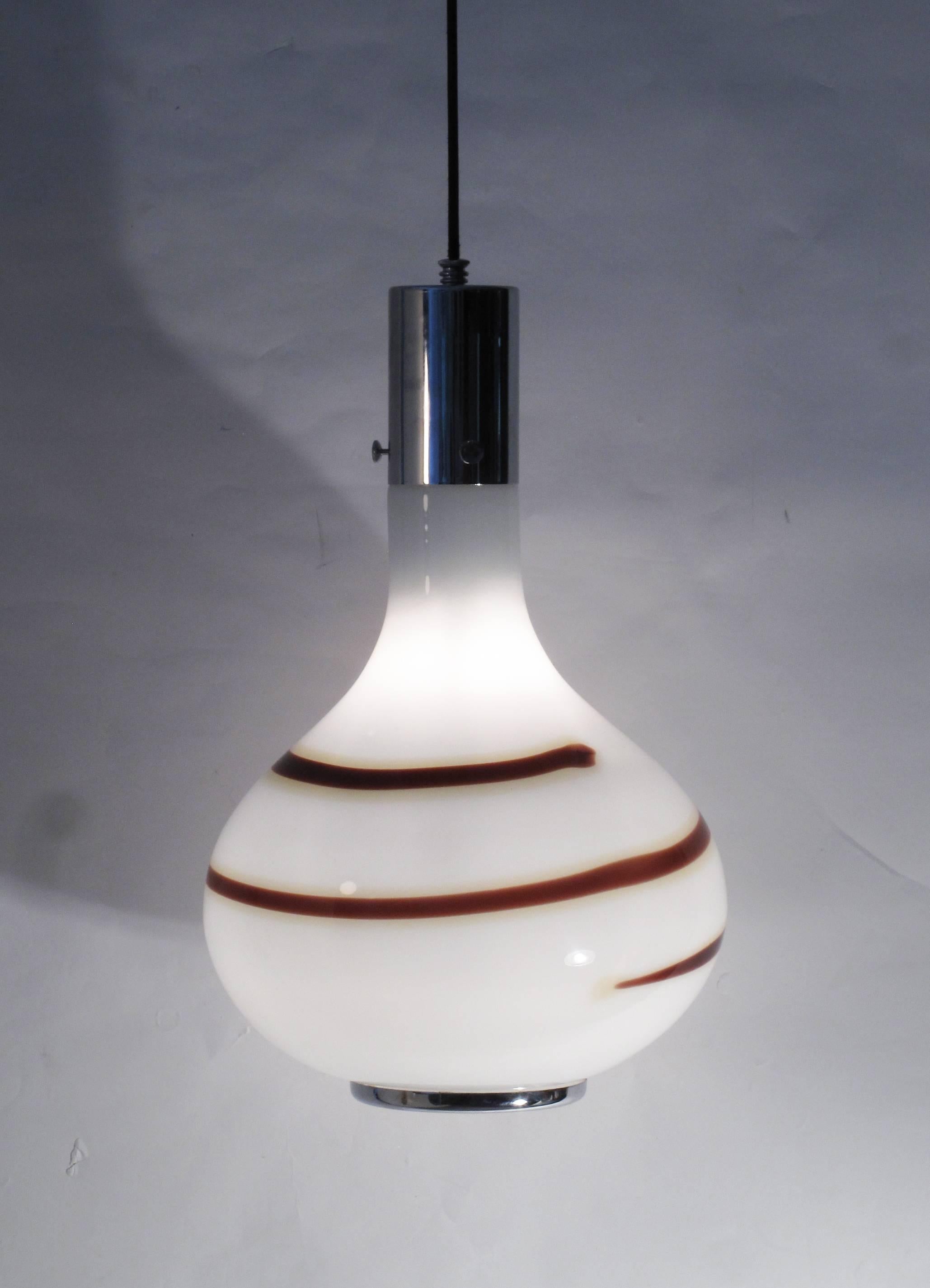 Pendant lamp made of white blown glass and carmel color line following the shape of the shade, the edge of it is finished with a steel chromed ring and top is suspended from a steel chroped cylinder.
