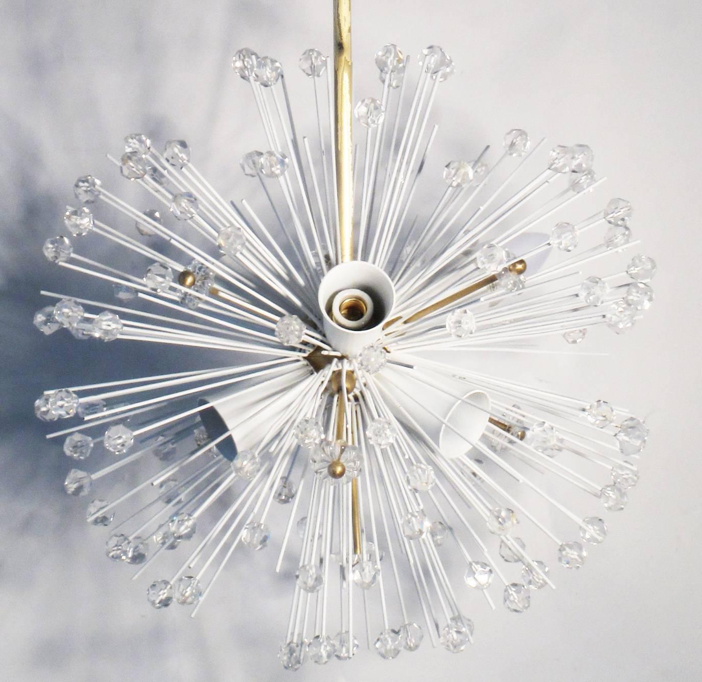 Superb glass and brass chandelier designed by Emil Stejnar in the early 1950s. The chandelier consist of a very long brass stem in one end of a brass ball, attached to it there are 7 arms with glass flowers and glass drops and 6 arms with bulb