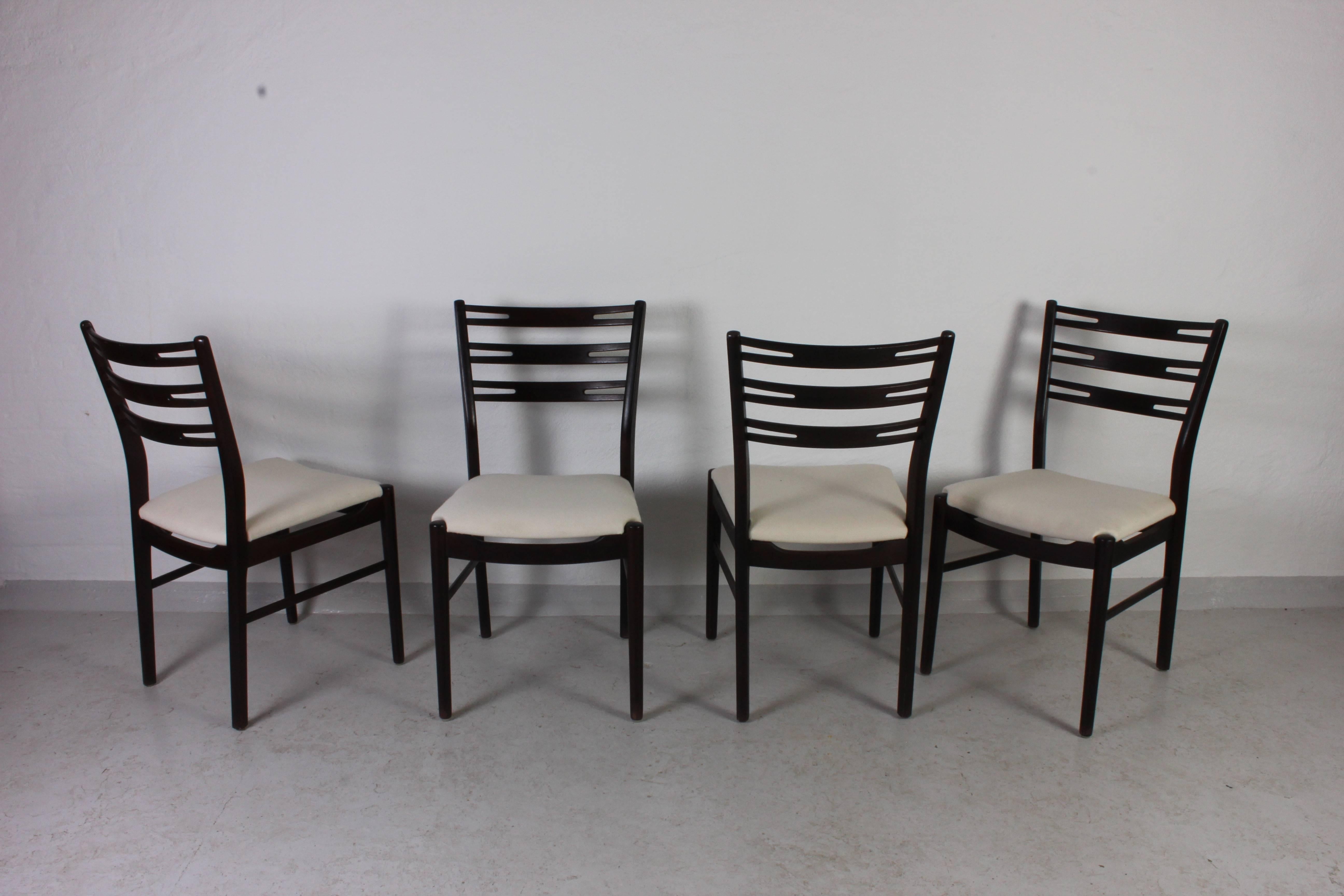 Set of four midcentury dining chairs by Danish manufacturer Sibast Møbler. The chairs are made of dark stained beech and new upholstery. The high back makes them very comfortable to sit in.