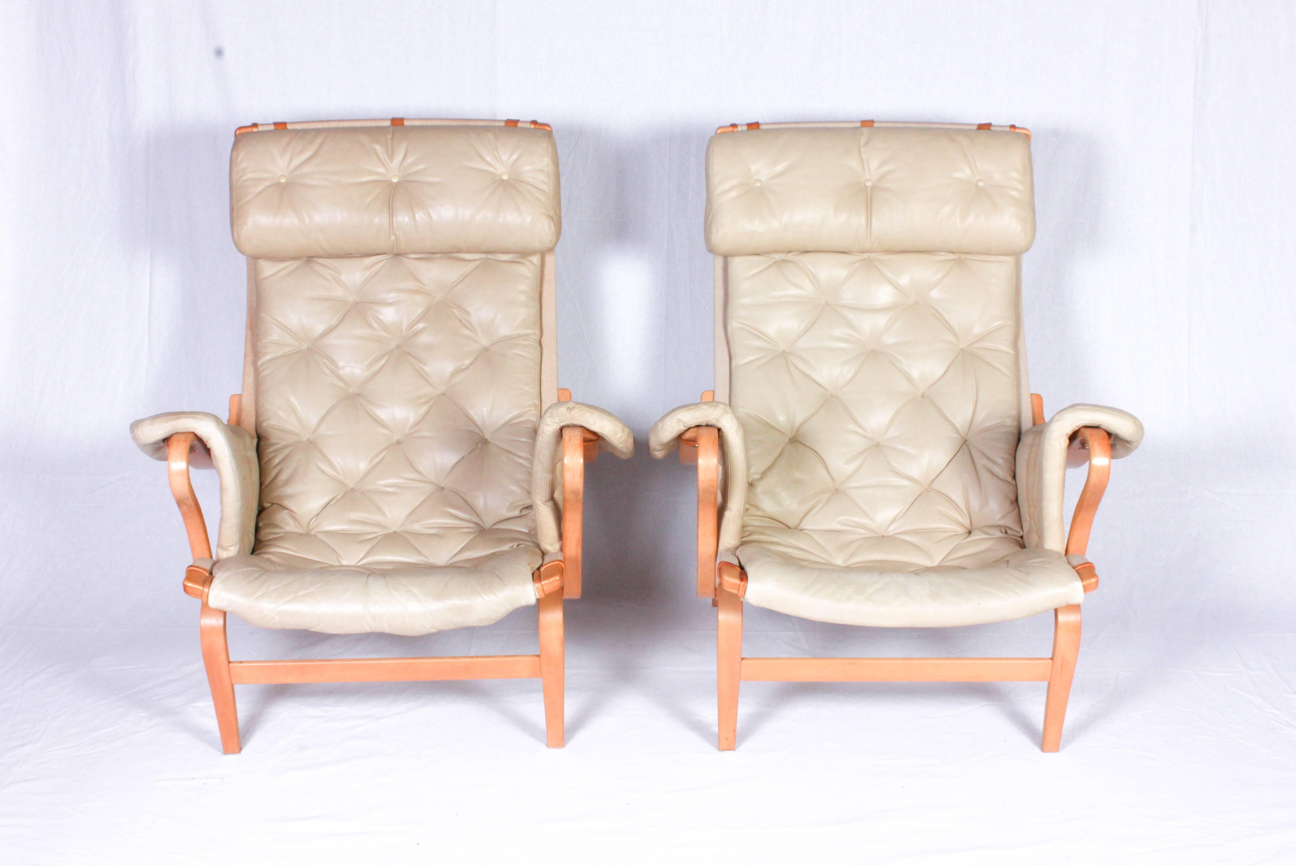 Tan leather lounge chairs of the model 