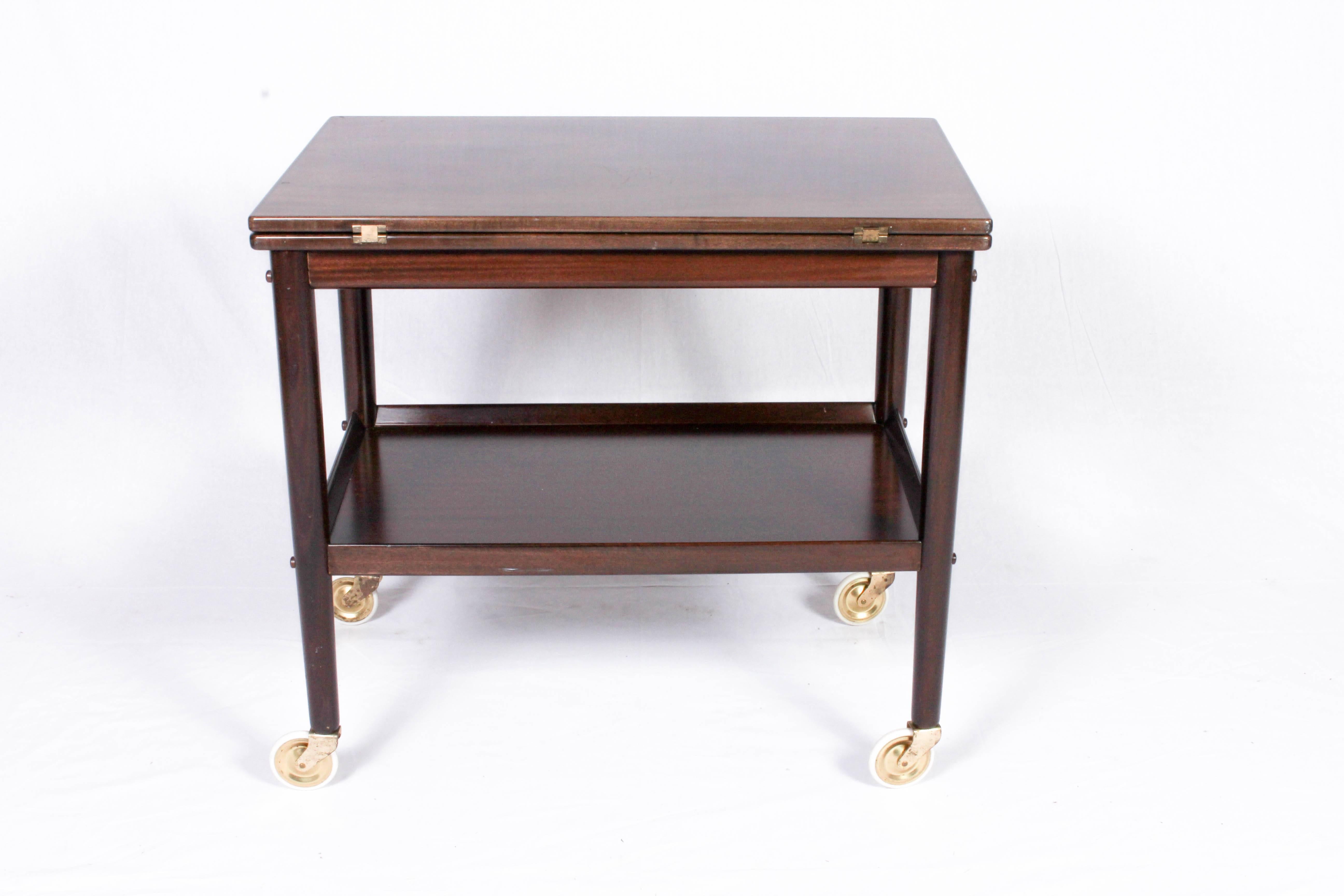 This mahogany serving cart was designed by Ole Wanscher for Poul Jeppesens dining set 