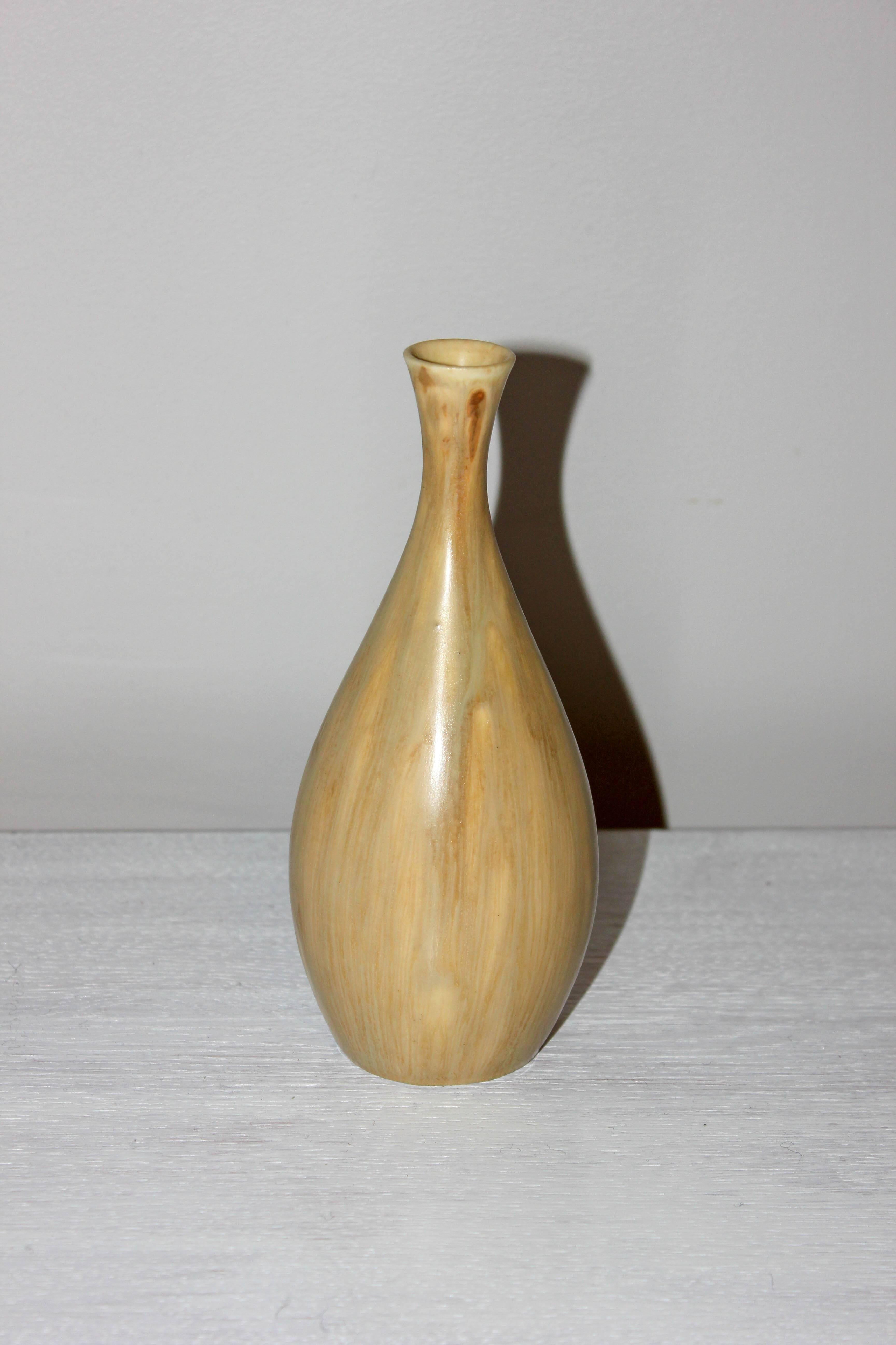 This midcentury Swedish ceramic vase was made by Carl-Harry Stålhane at the Swedish company Rörstrand. The vase has a clean minimalistic design and is in good vintage condition.