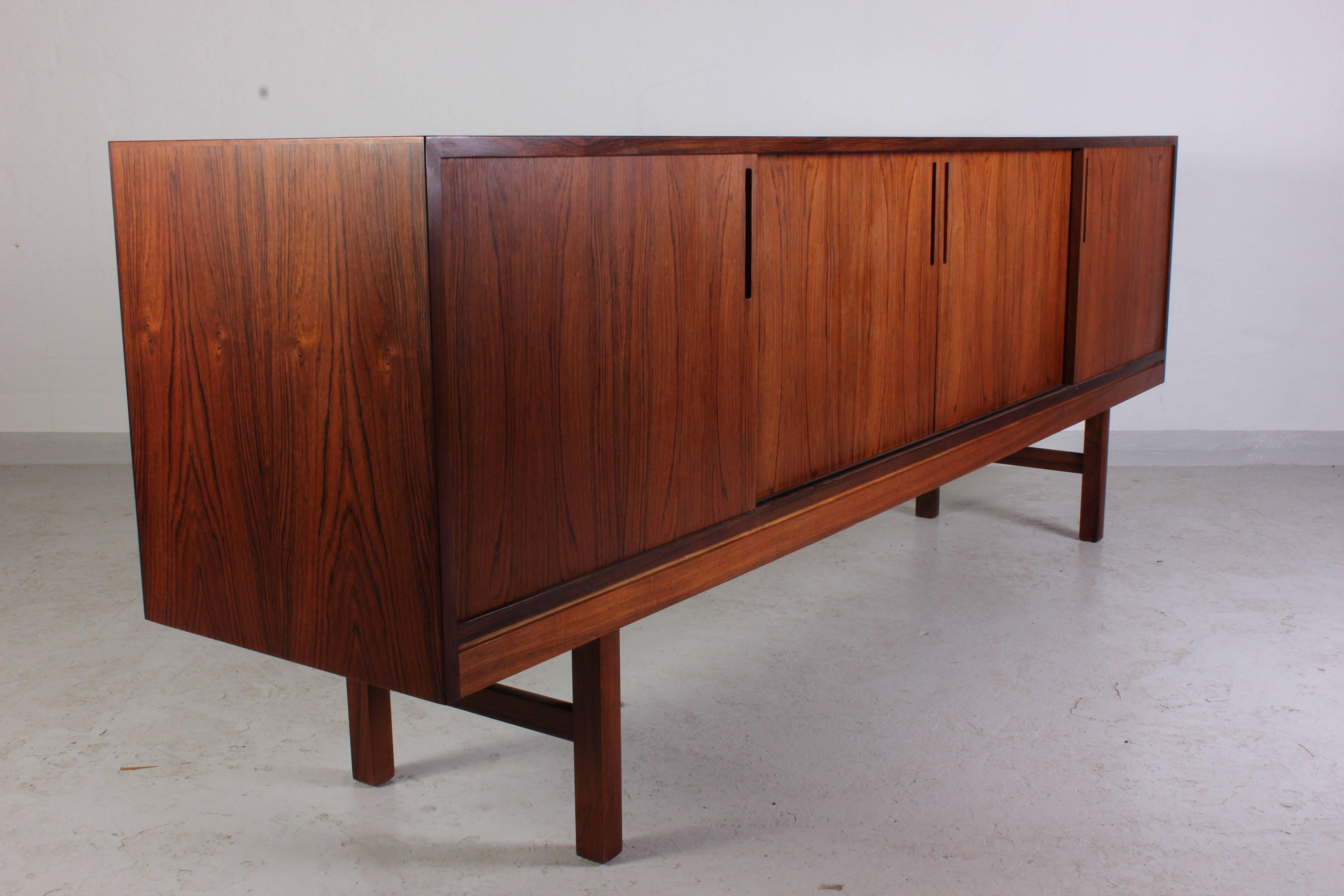 Midcentury Danish rosewood sideboard in very good vintage condition. The sideboard has plenty of nice details and it is a long model that measures 220cm in width. The sliding doors and the joints of the drawers are just some examples of the high