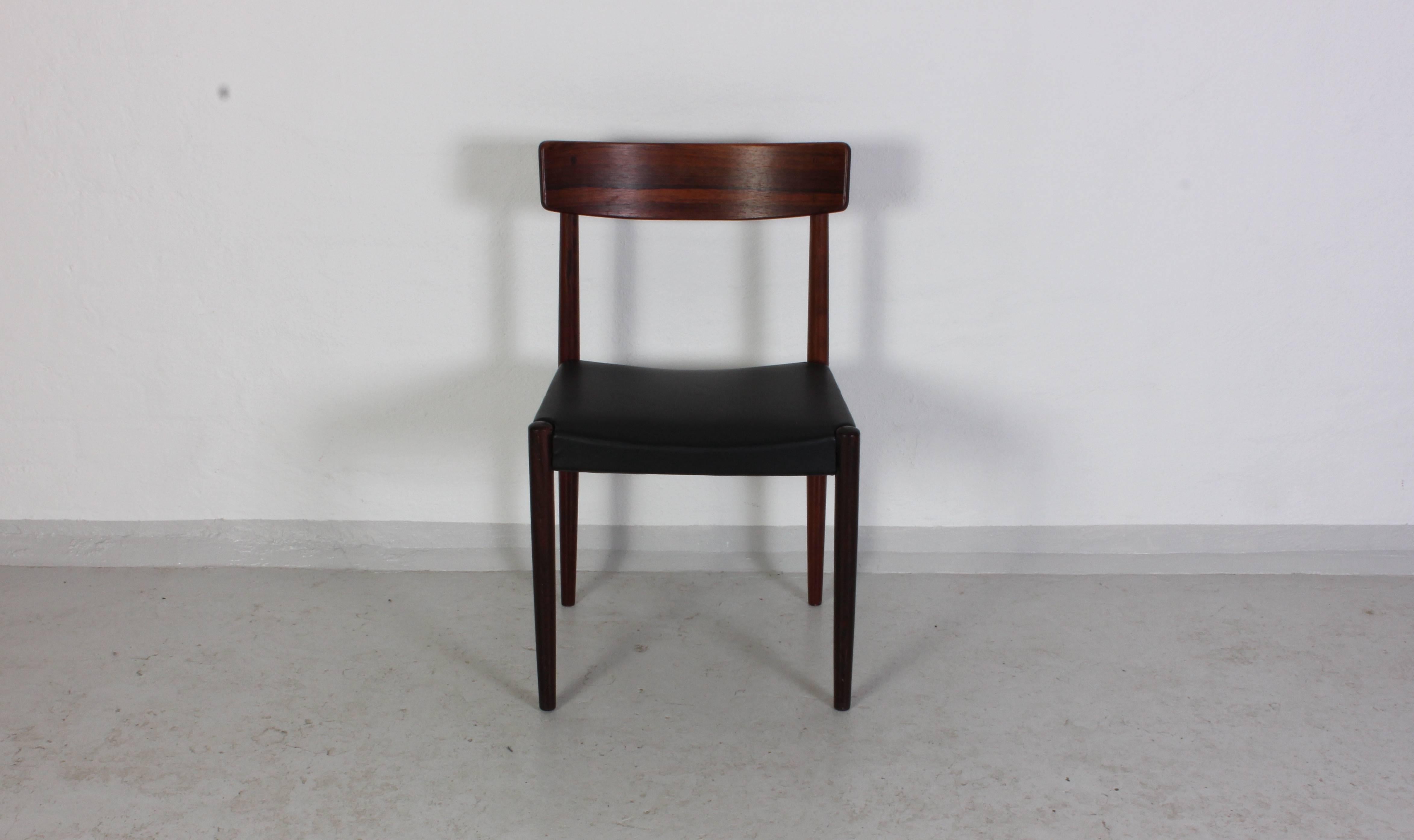 Set of four rosewood dining chairs by Swedish designer Nils Jonsson manufactured by Troeds in the 1950s. The chairs are made of rosewood with nice grain and they have new faux leather upholstery (consistent with the original upholstery). They are