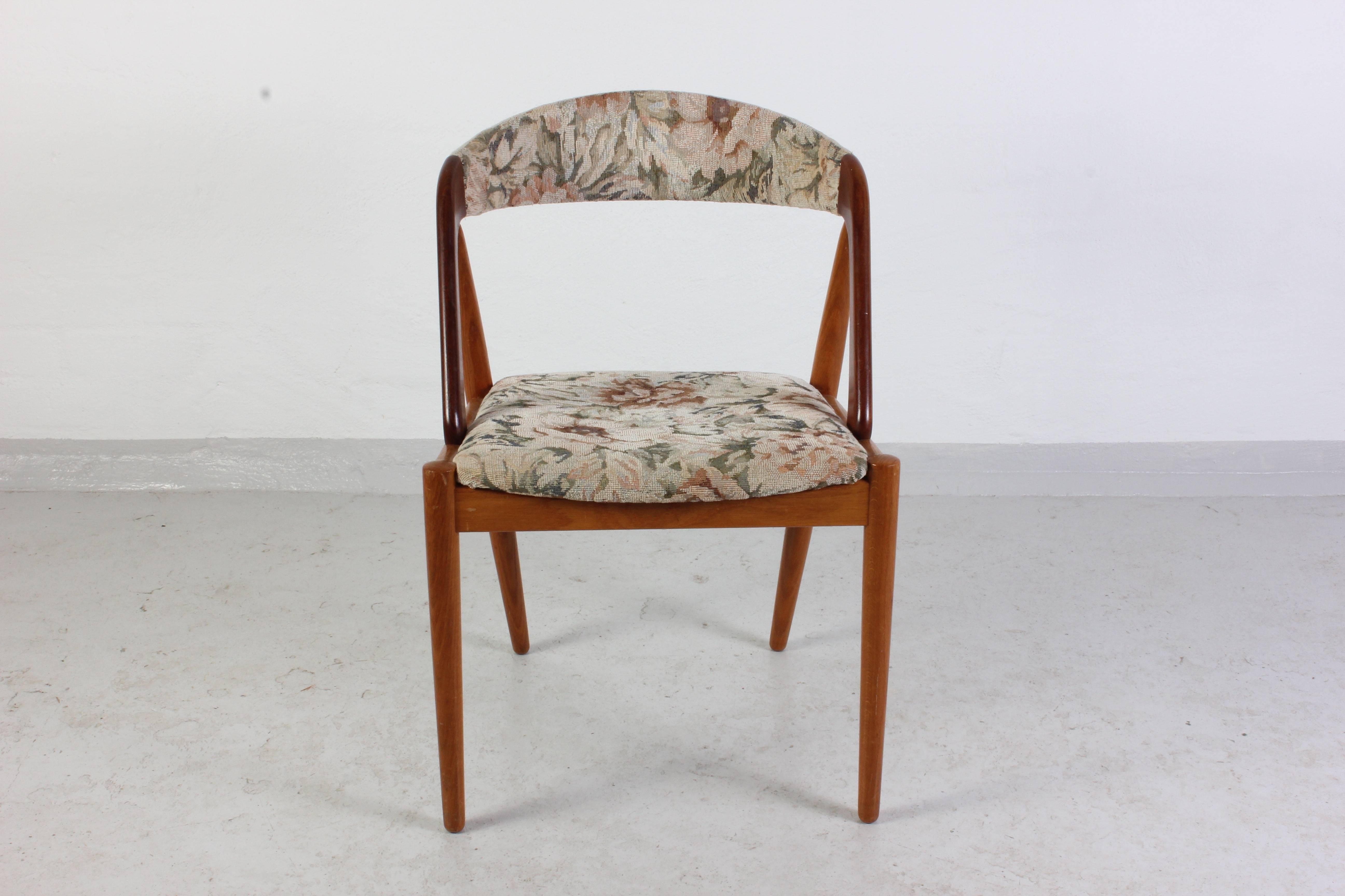 Set of six midcentury dining chairs by designer Kai Kristiansen. The chairs are all in very good vintage condition as well as the upholstery; however there are a few rivets that fastens the fabric on the backrest missing.