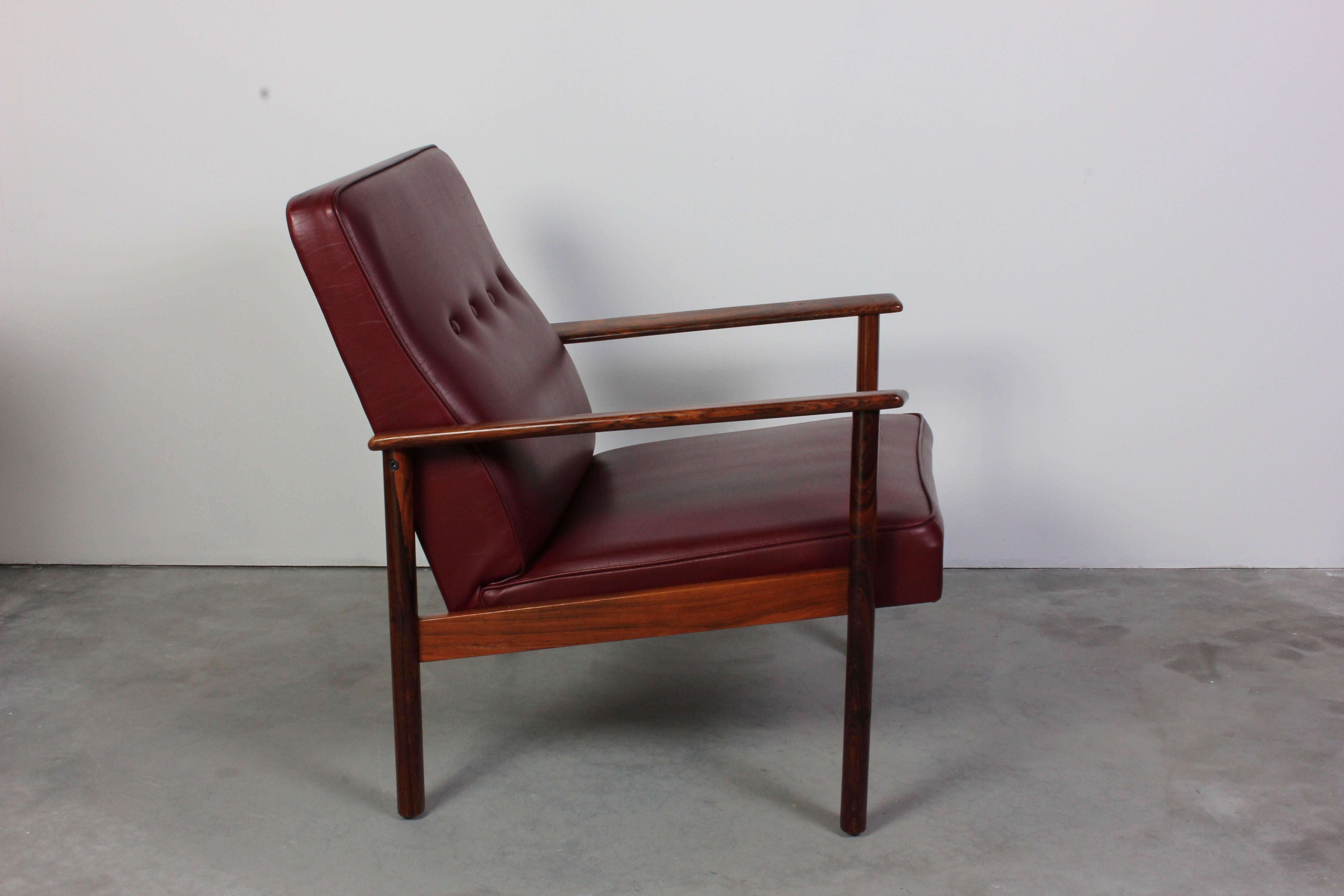 Midcentury rosewood lounge chair by unknown scandinavian designer. The chair is made out of rosewood with nice grain and original leatherette upholstery. The chair is in very good vintage condition with minor signs of usage (small signs on