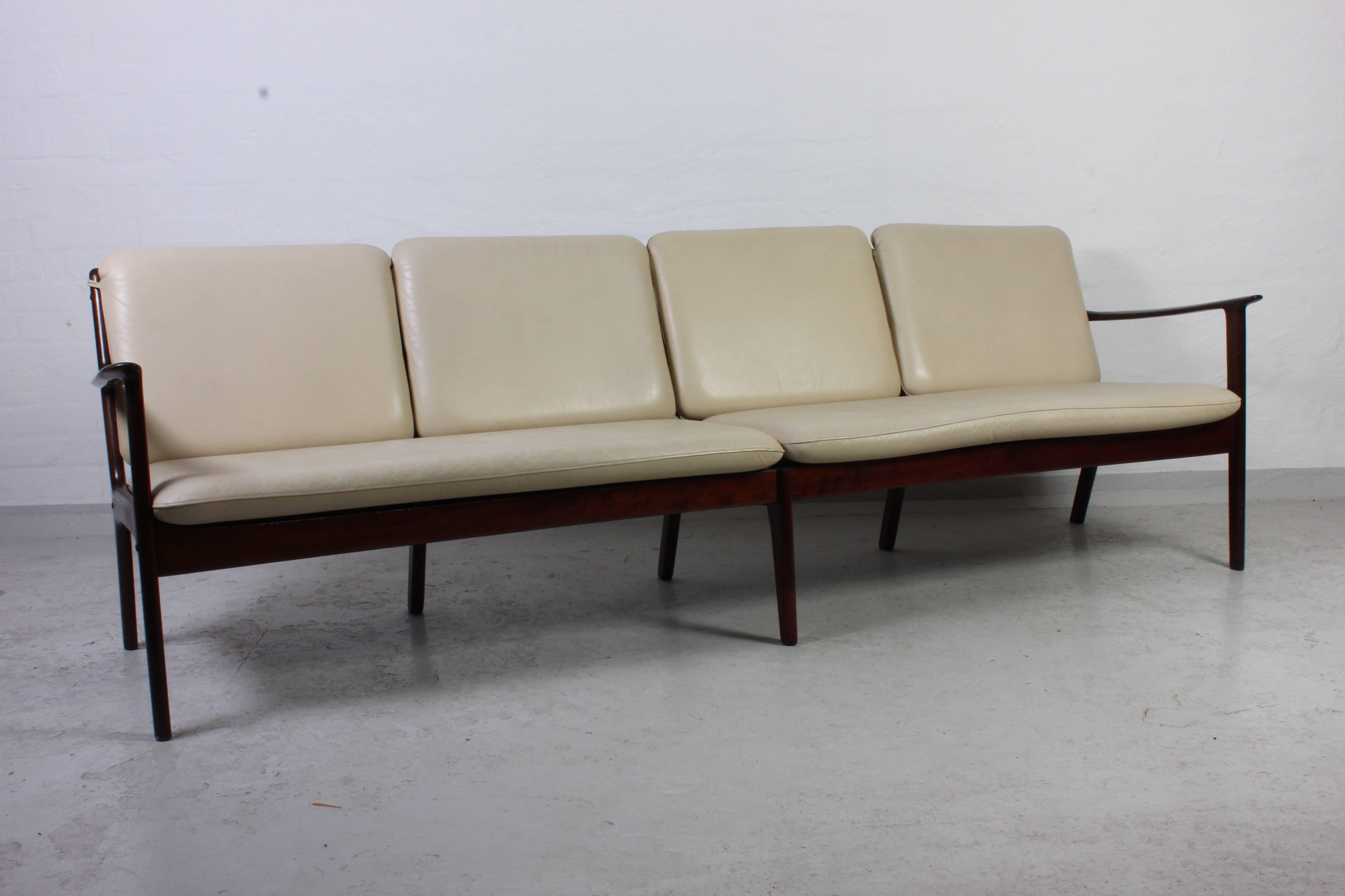 Midcentury four-seat sofa and lounge chair by famous Danish designer Ole Wanscher. This mahogany sofa set was produced by Poul Jeppesen in the 1950s. Sofa and chair has original skai upholstery in good vintage condition. The wooden frames is in very