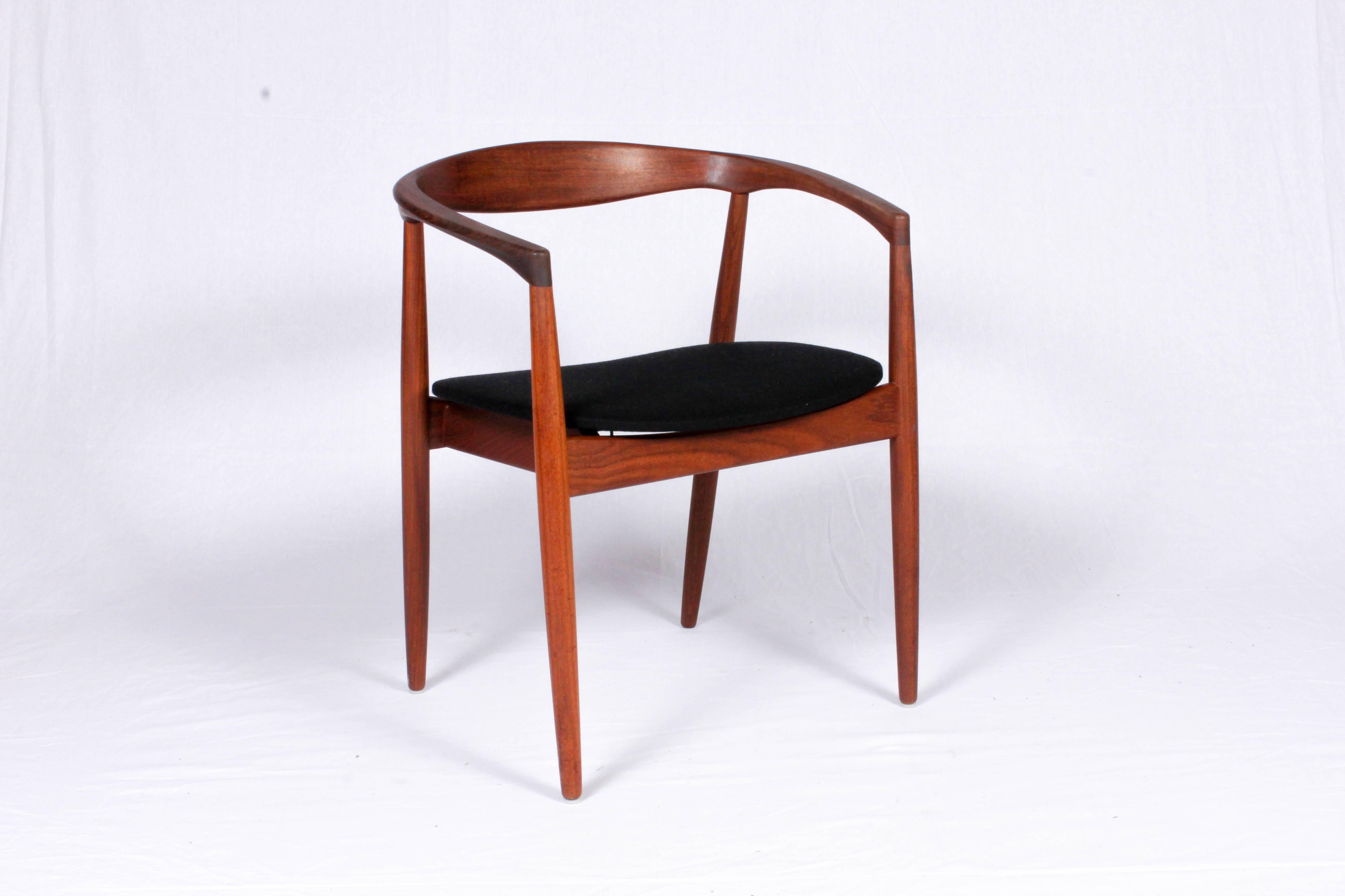 Midcentury teak armchair designed by Kai Kristansein. The model is called Troja and is made out of solid teak. The seat is reupholstered in a high quality black 100% wool fabric which is perfect for this chair. 

The chair is in excellent vintage
