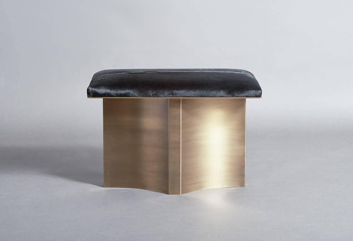 V brass bench with black hair on hide cushion and finished in a linear aged brass, transforms the everyday bench into a luxurious objet d'art. 
Customization available. Please inquire for additional information.

Featured in Elle Decor. 

Designed