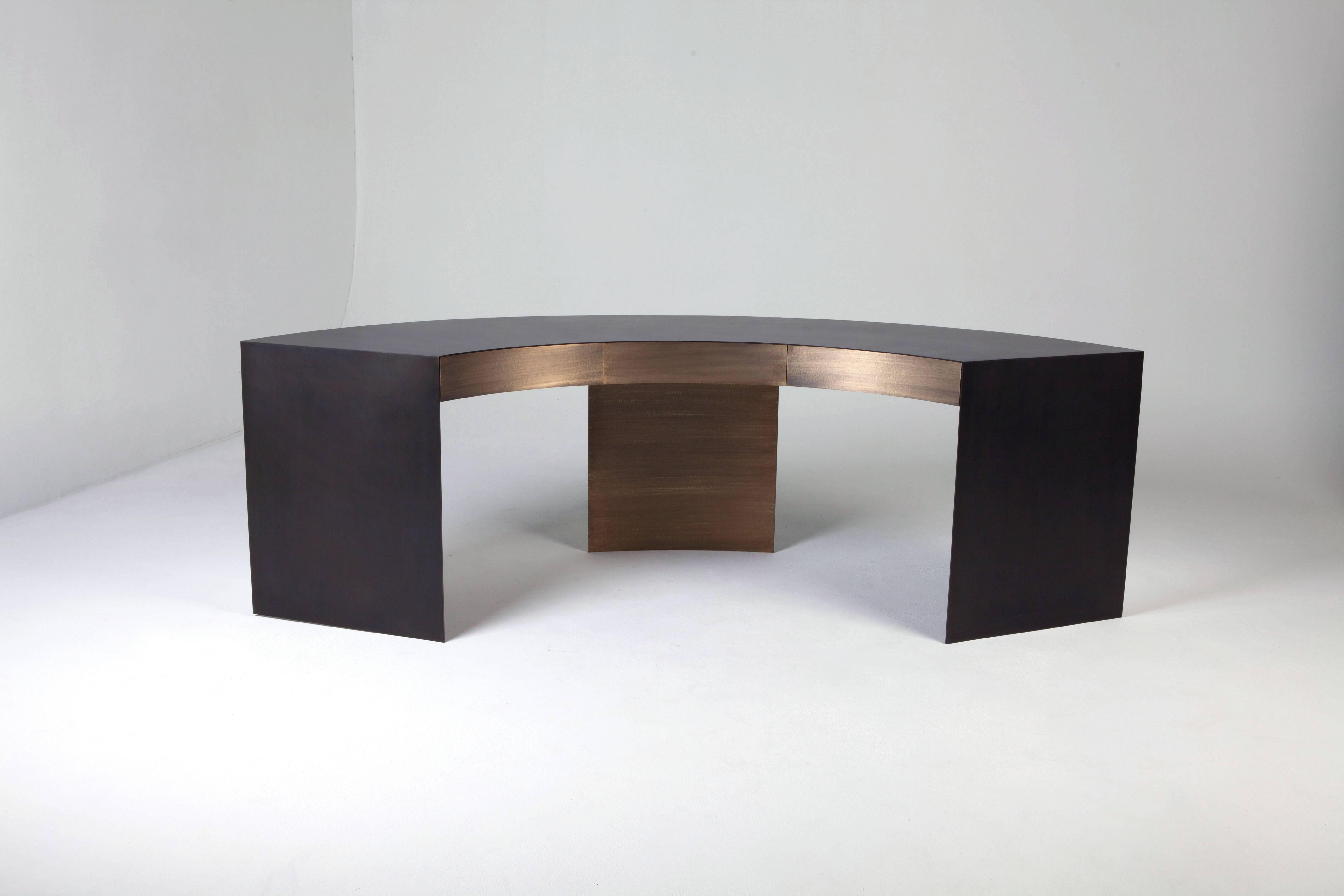 EPIC metal desks semi-circle embodies power and confidence. The finishes consist of a Handcrafted textured aged brass front center leg and three drawer fronts and a black bronze steel top and outer legs.

Customization available upon