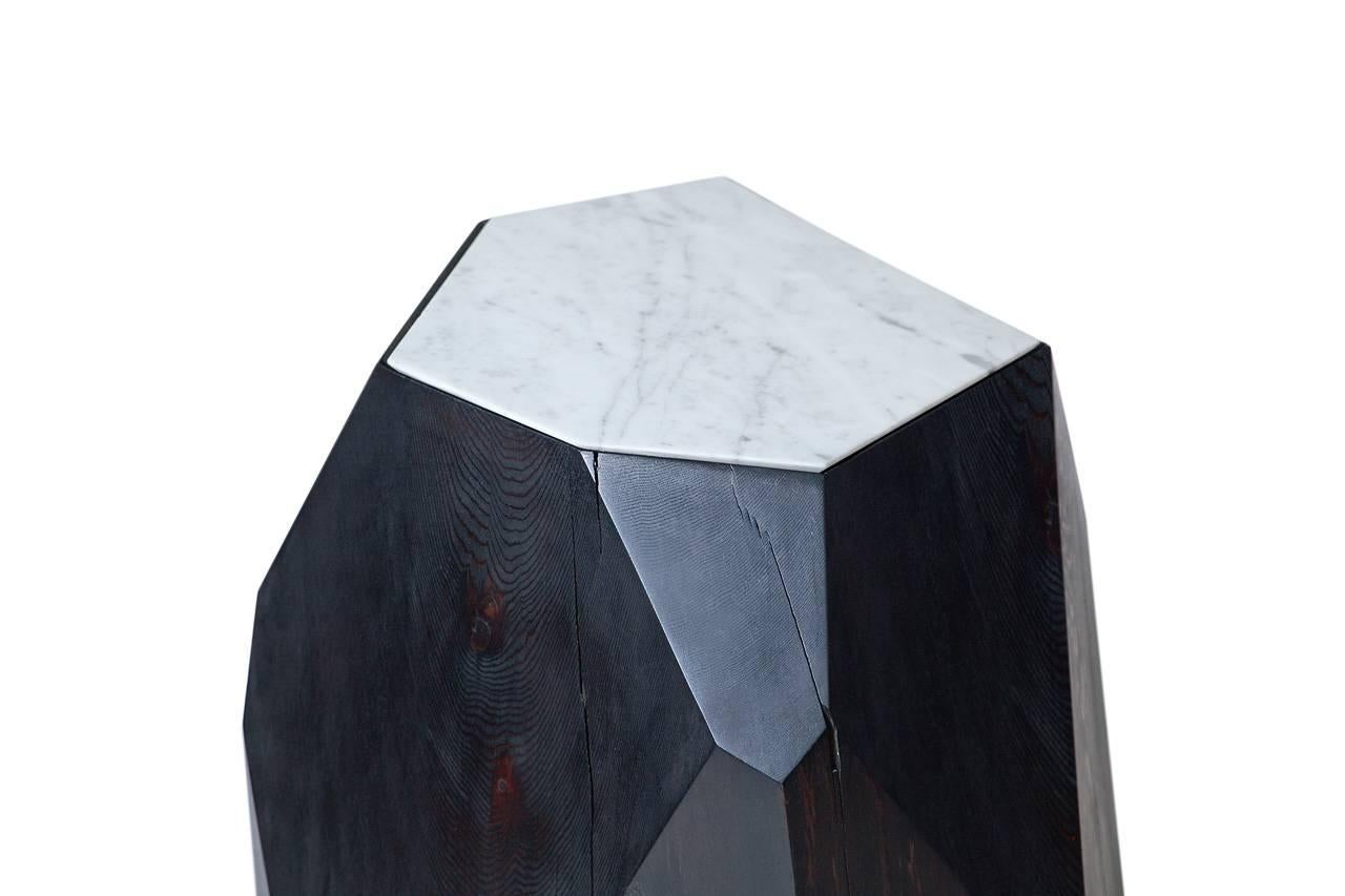 Cast-off cedar logs are given second life as a crystalline form. Named Little Gem, the natural beauty of reclaimed wood is harnessed in this side table and sculpture piece where nature informs design. Each Little Gem is hand-shaped and faceted based