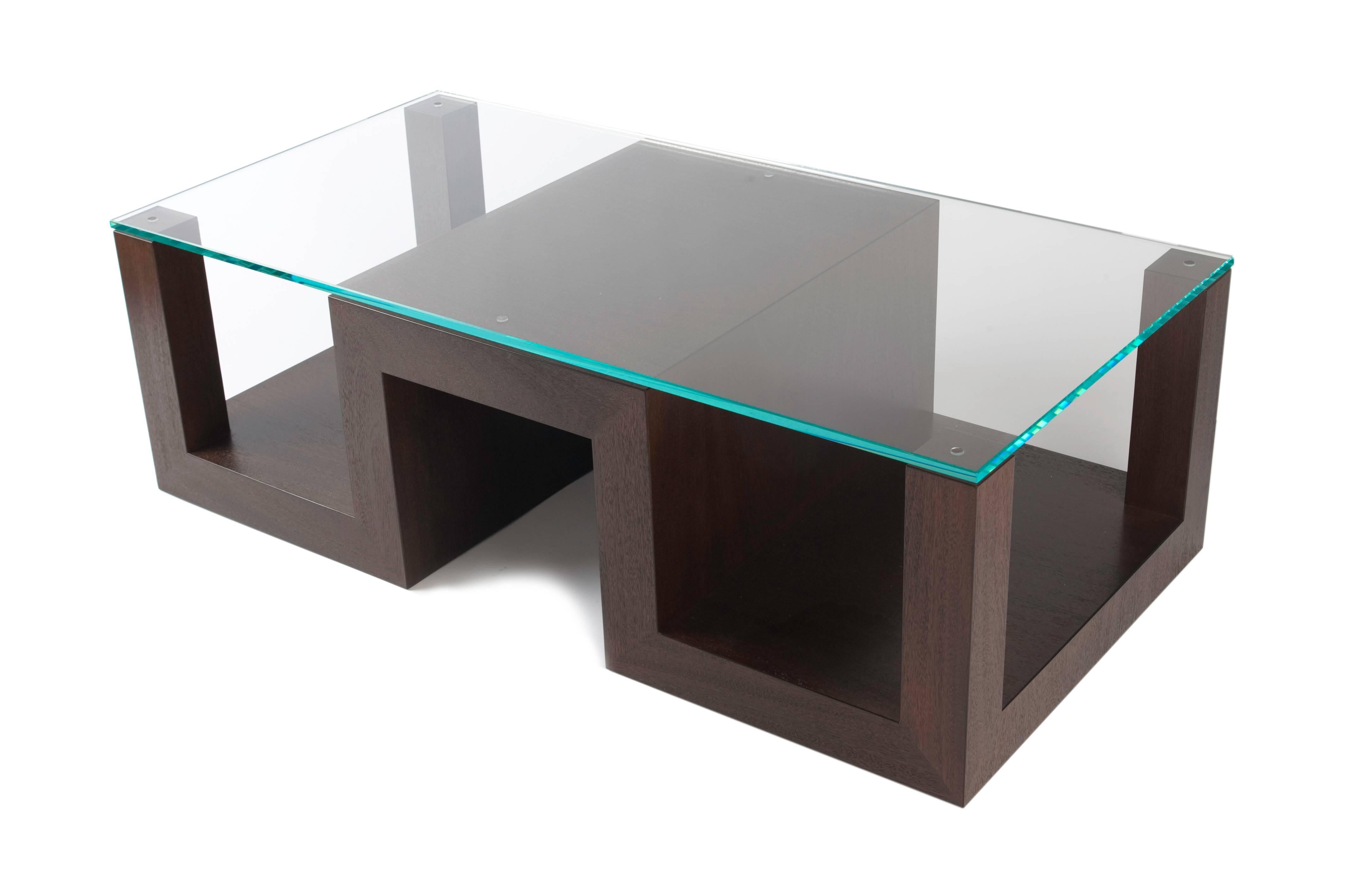 The five points table is a more traditional take on a coffee table. The five subtle contact points of the beautifully hand-finished wood base are a perfect complement to the steel-cut-glass.