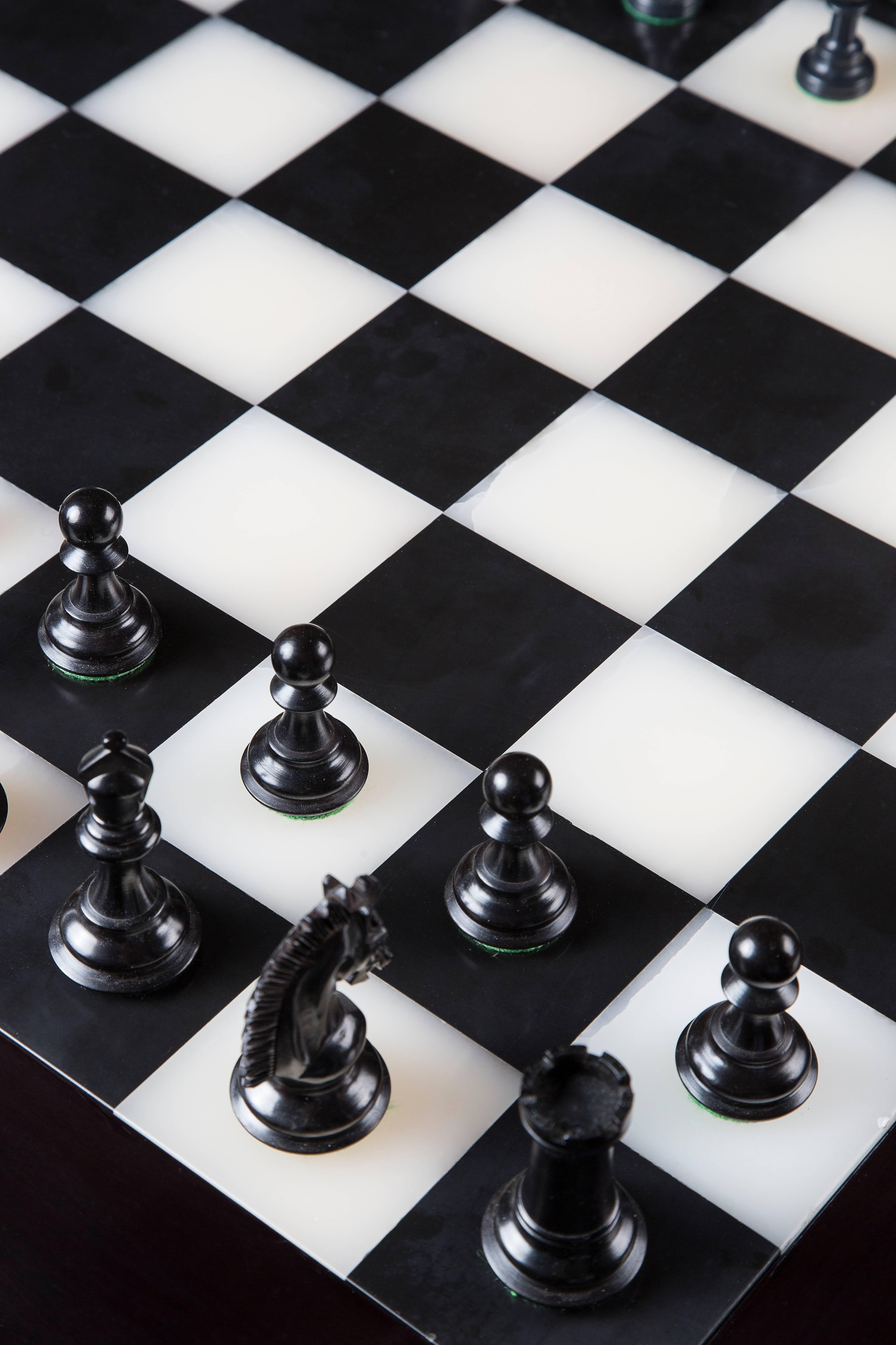 This custom-made chess table comes from Rinck cabinetmaking collection. Fabricated in France in 2010.

Details:

Dark wood 
Chased gilt bronze set,
High gloss varnish finishing
Can be available in rosewood, sycamore and ebony veneer.
 