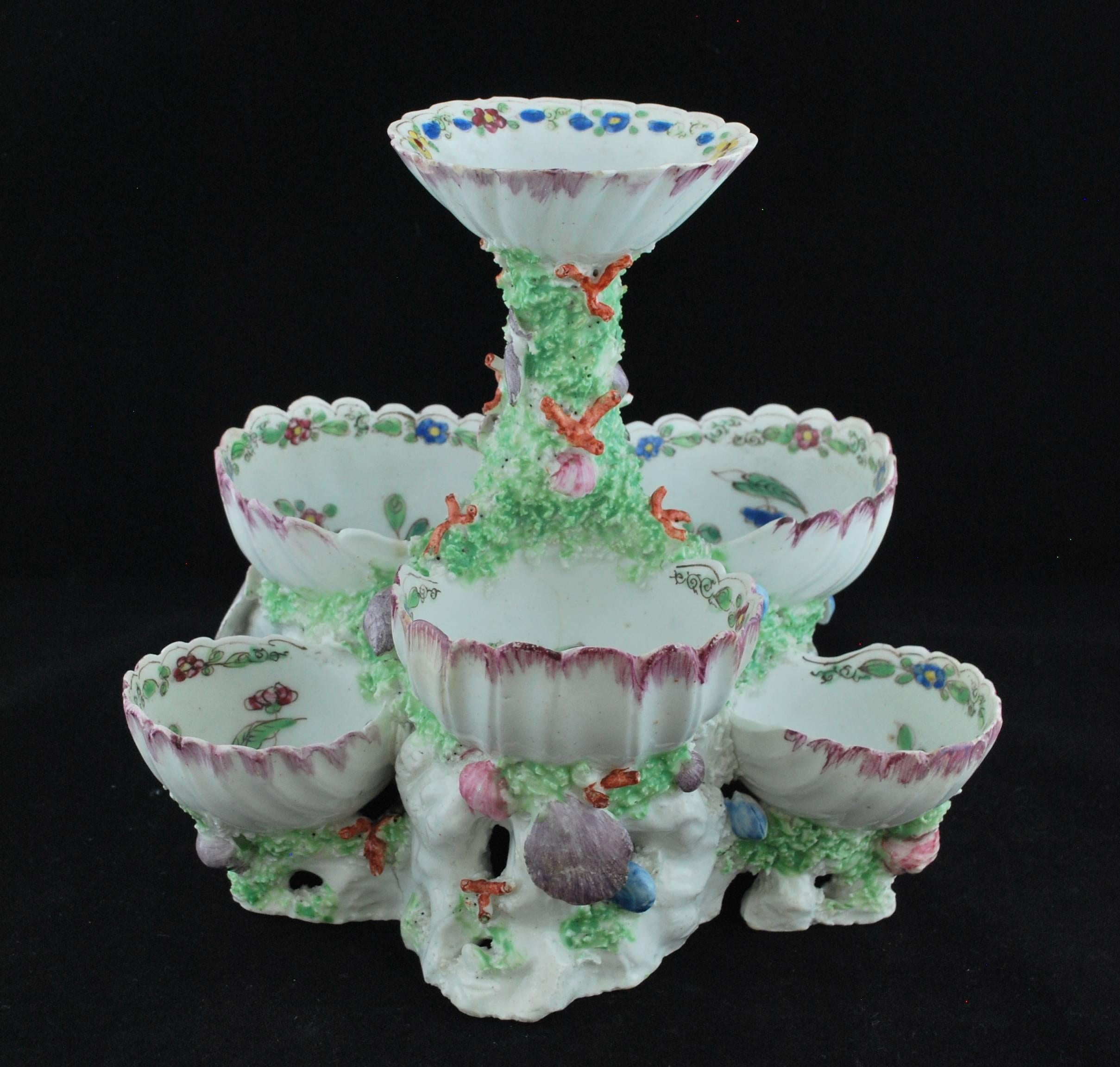 Three-tiered stand for sweetmeats, in the form of shells and coral, and enameled with flowers; it is rare to find these in such good condition. Probably from a large dessert service.

These stands were popular in the Georgian period and were made