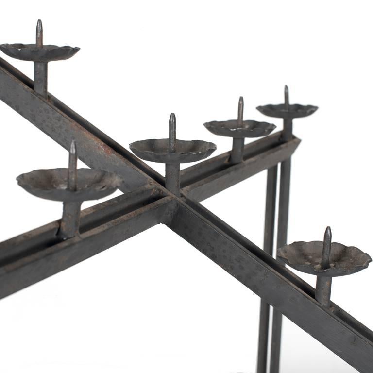 Black wrought iron Candelabra in the shape off a cross.
Beautiful table centre piece.
