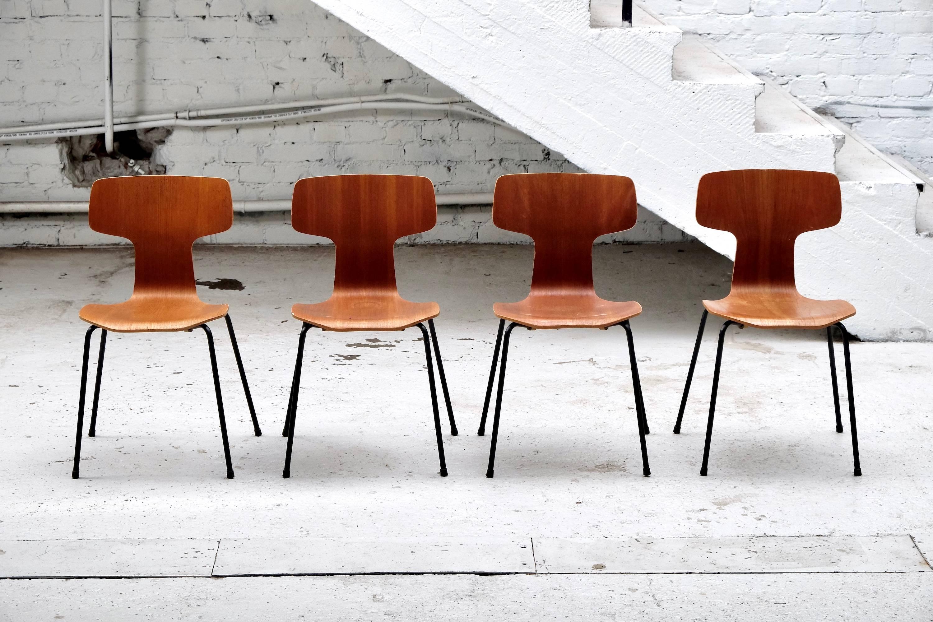 Set of four teak veneered chairs model 3103 by Arne Jacobsen. Black rubber coated tubular steel legs. Designed in 1957, these four chairs were produced by Fritz Hansen in 1964. They were only produced for a period of around 15 years.