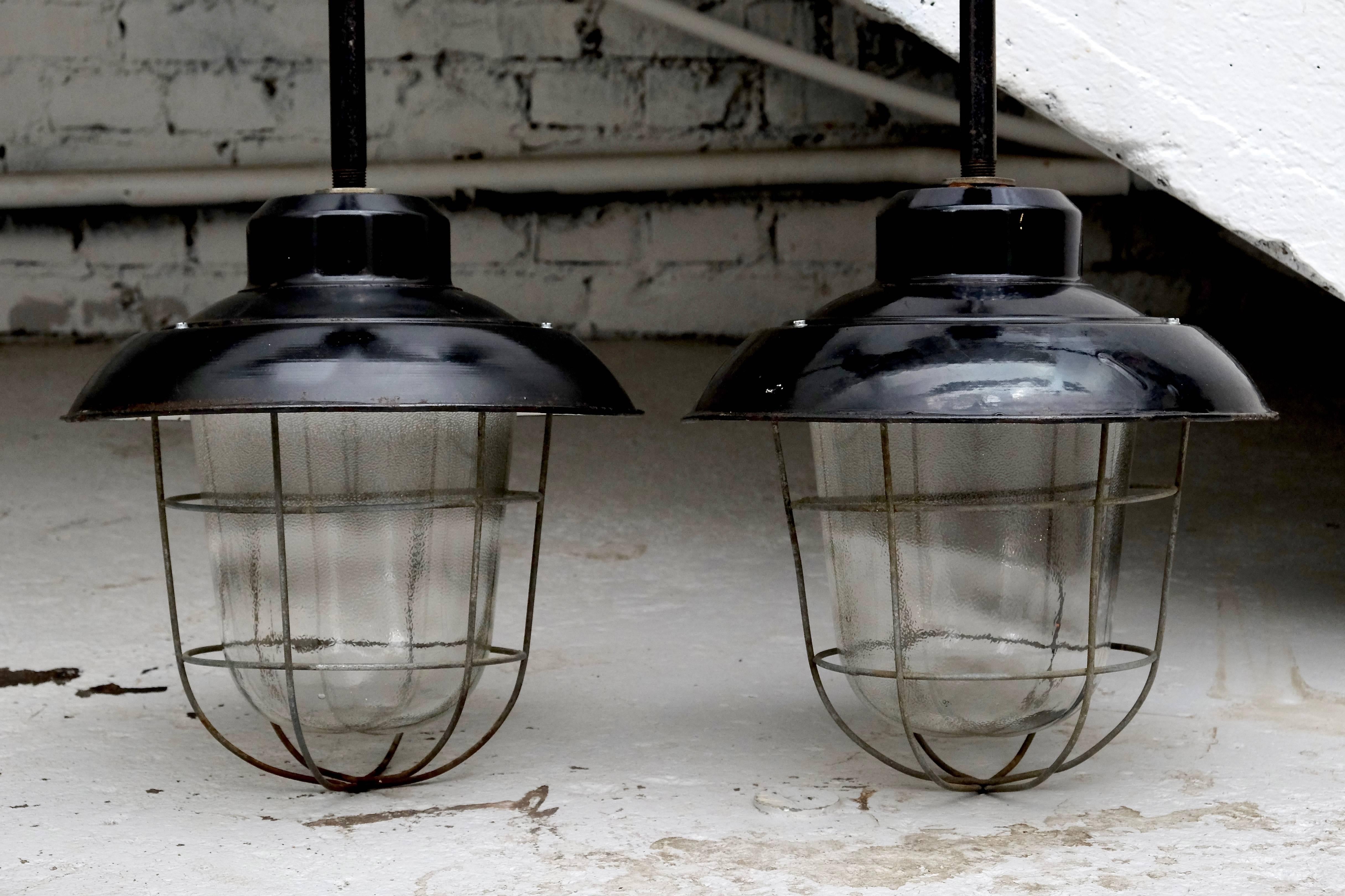 Pair of old black shade factory lamps with a metal cage around the bulb. New wiring, E27 socket.
    